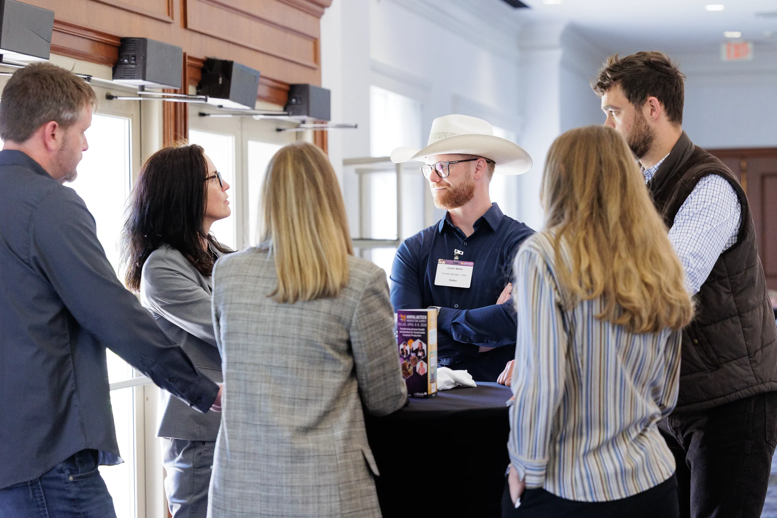 Group of attendees converse together during networking session at Chicago industry conference