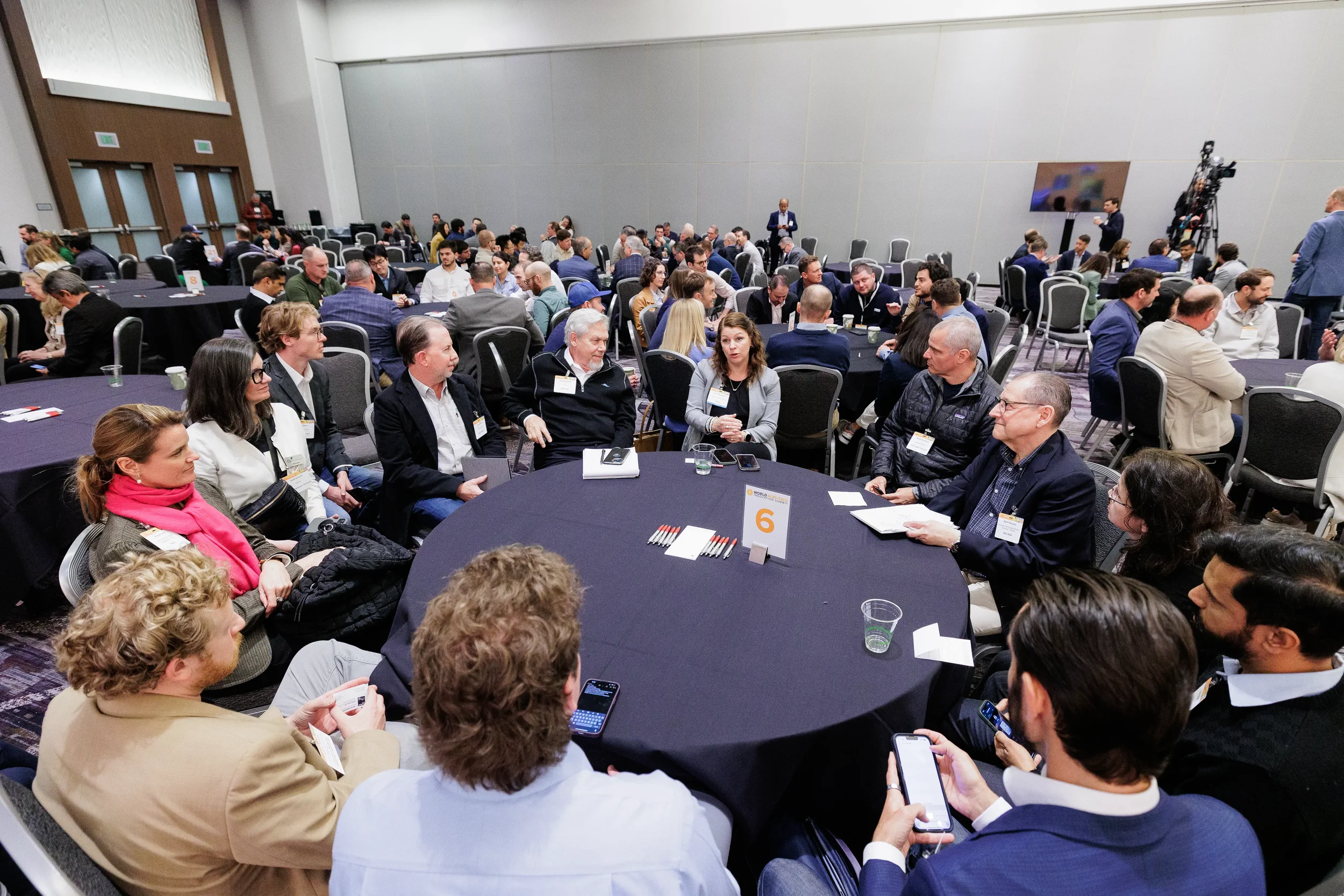 Wide view of attendees in discussion at roundtable during Chicago corporate conference