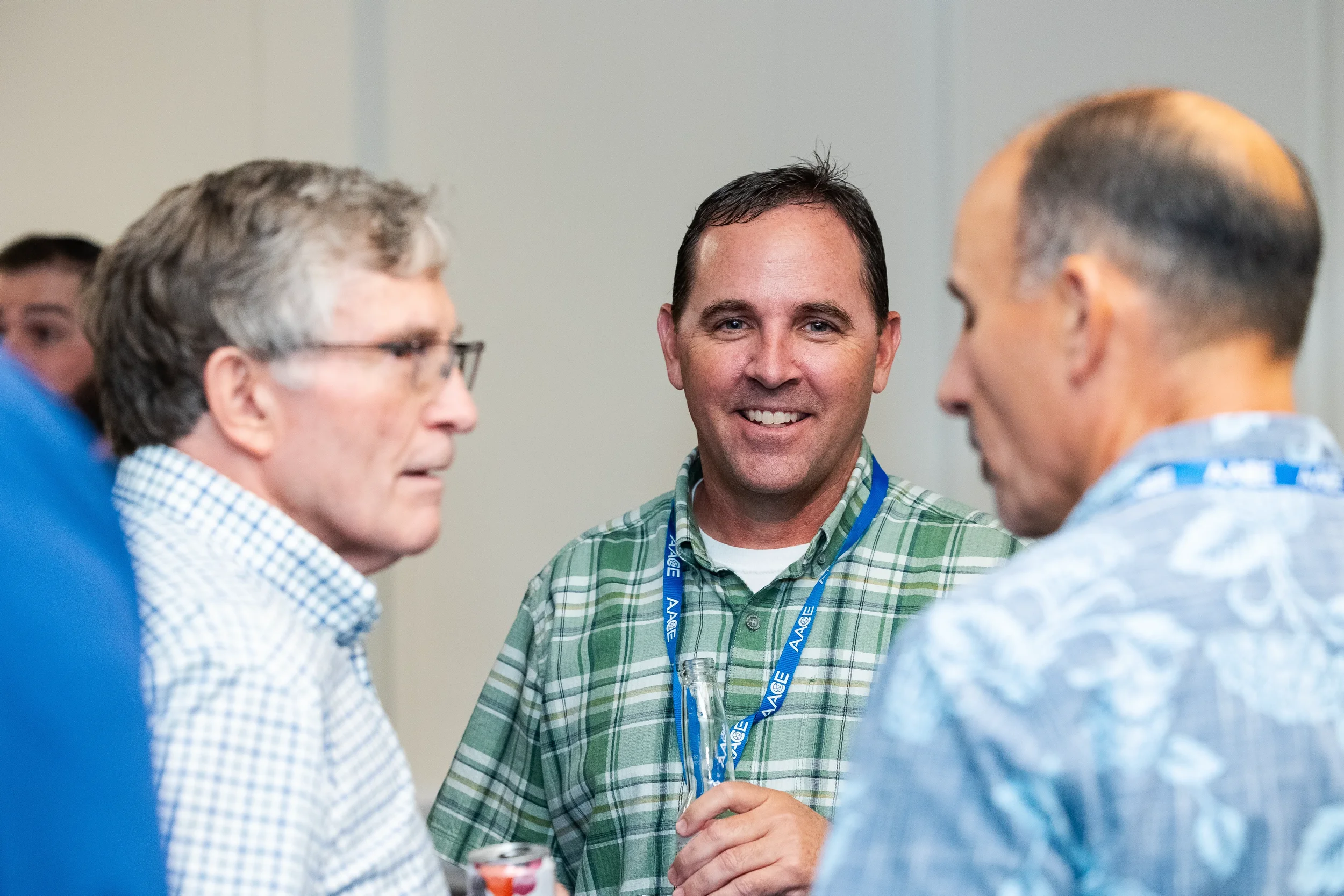 Three conference attendees share a conversation during networking reception at Chicago event