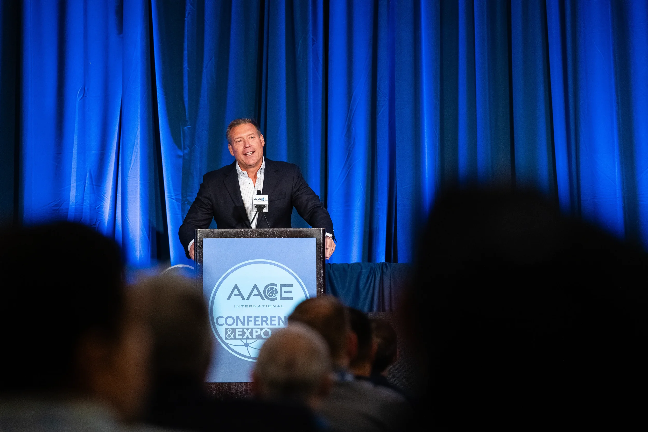 Speaker presents from stage at AACE International Conference & Expo in Orlando