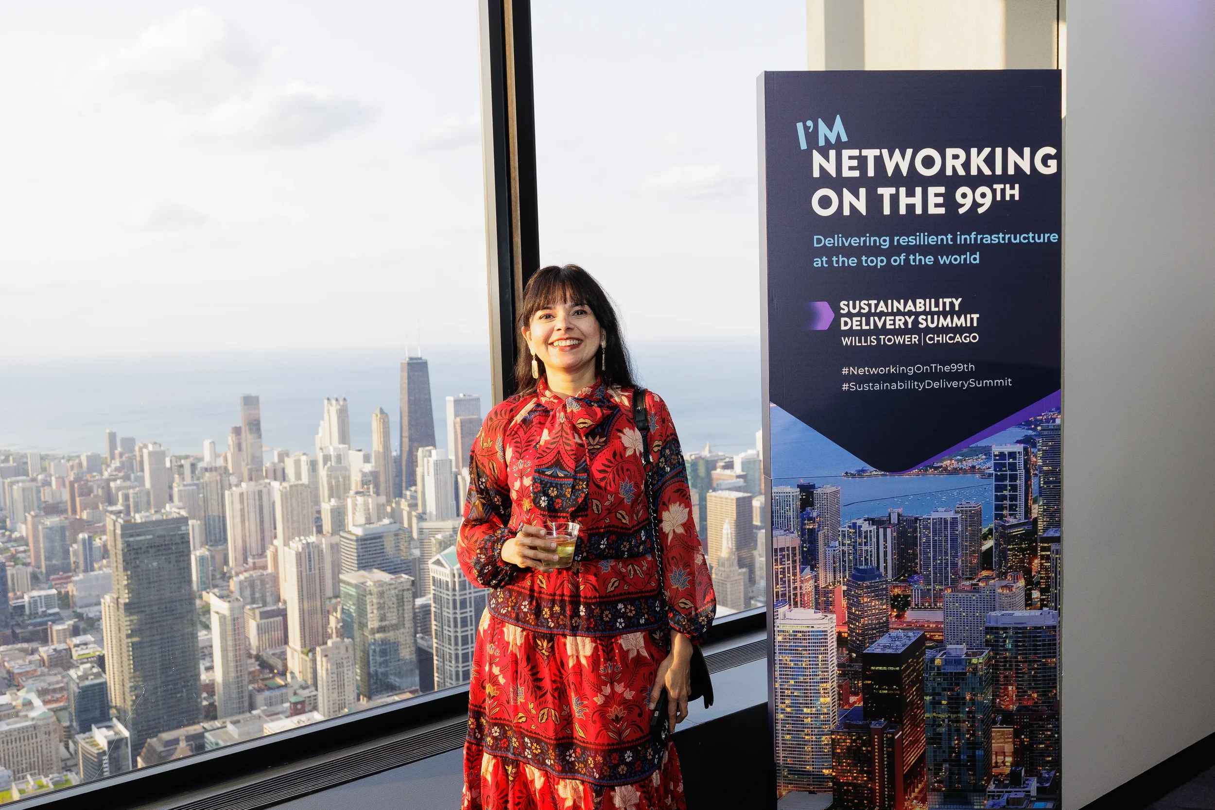 Attendee poses with skyline view in background during Orlando corporate event reception