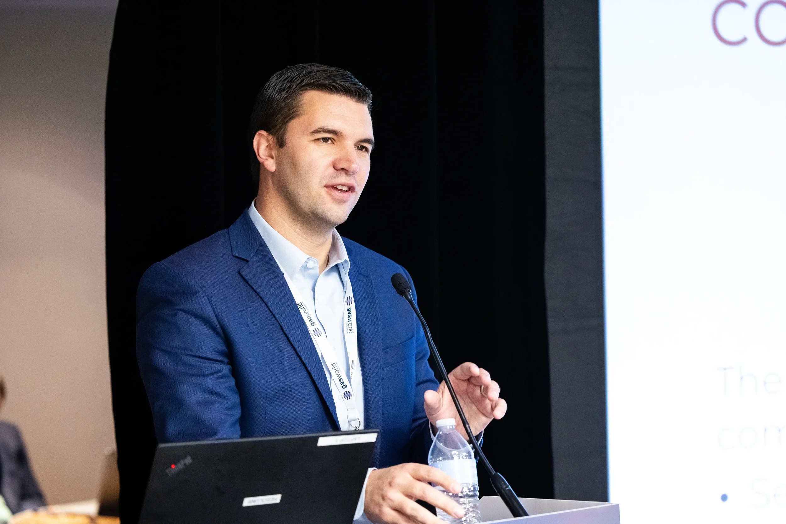 Conference speaker addresses audience from podium with microphone at Chicago corporate event