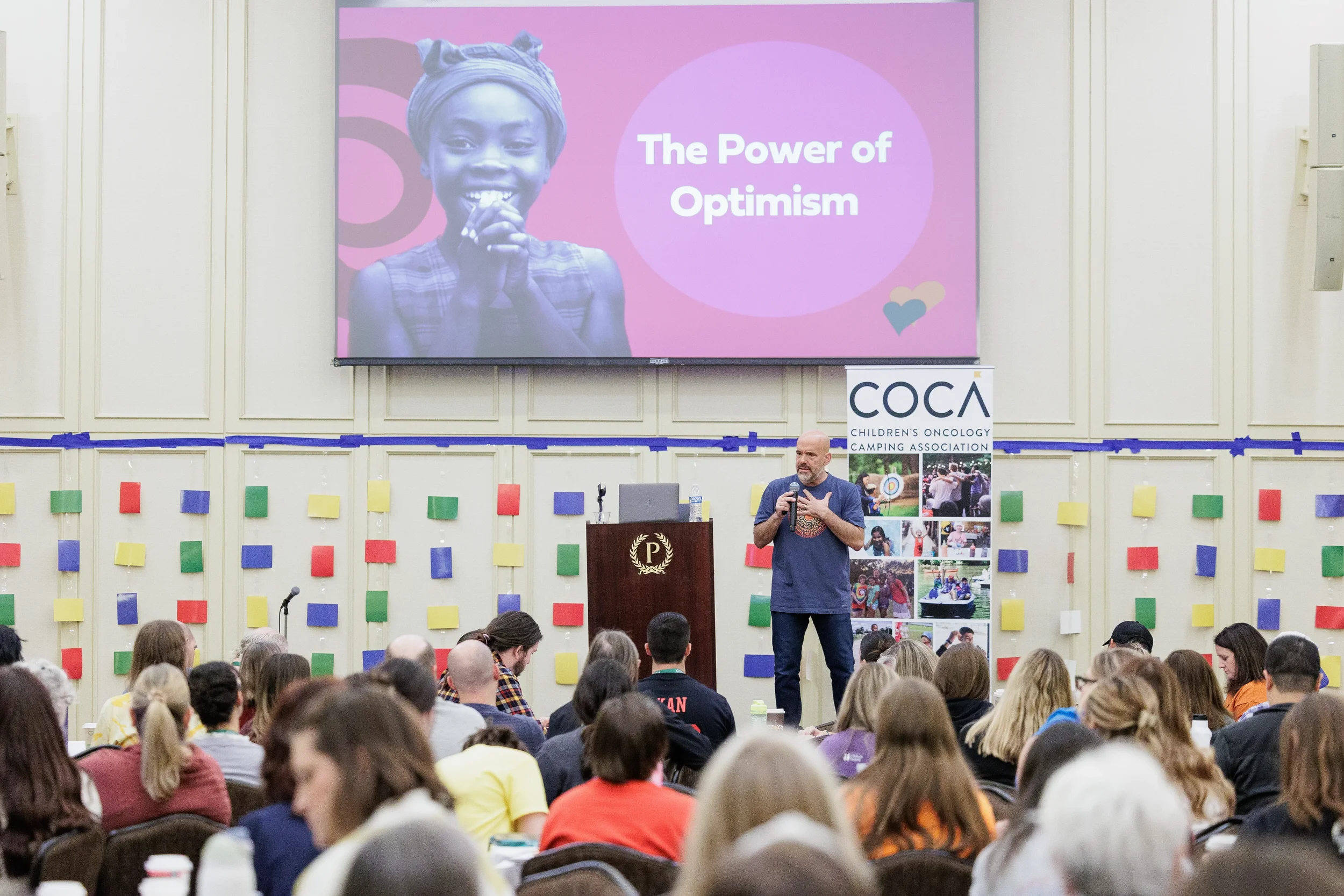 Keynote speaker presents to packed audience from podium at Chicago nonprofit conference