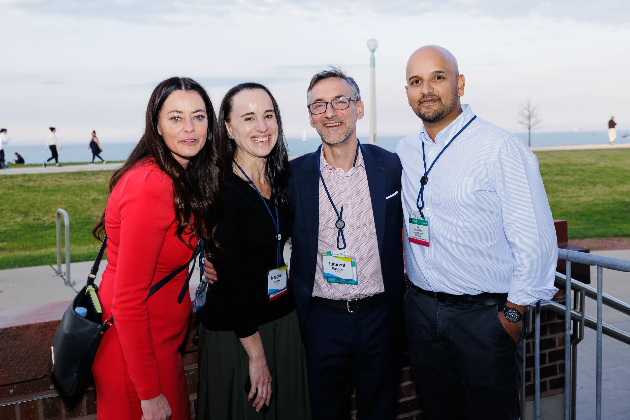 Four attendees pose together at outdoor lakefront reception during Orlando networking event