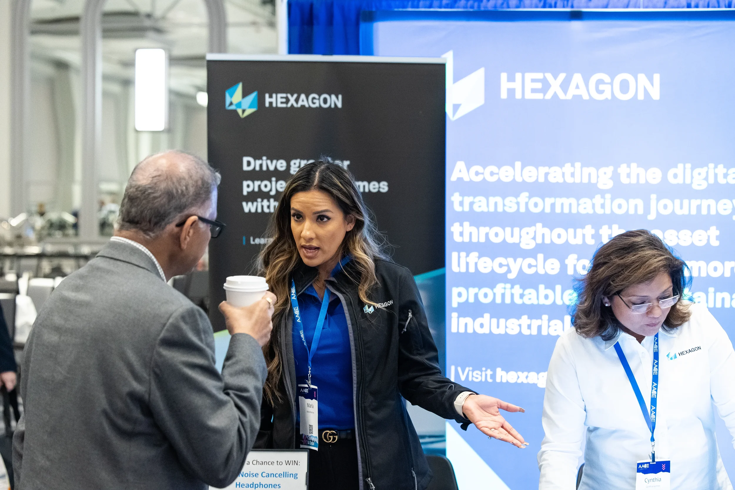 Trade show exhibitors speaking with attendee at expo booth during Chicago conference