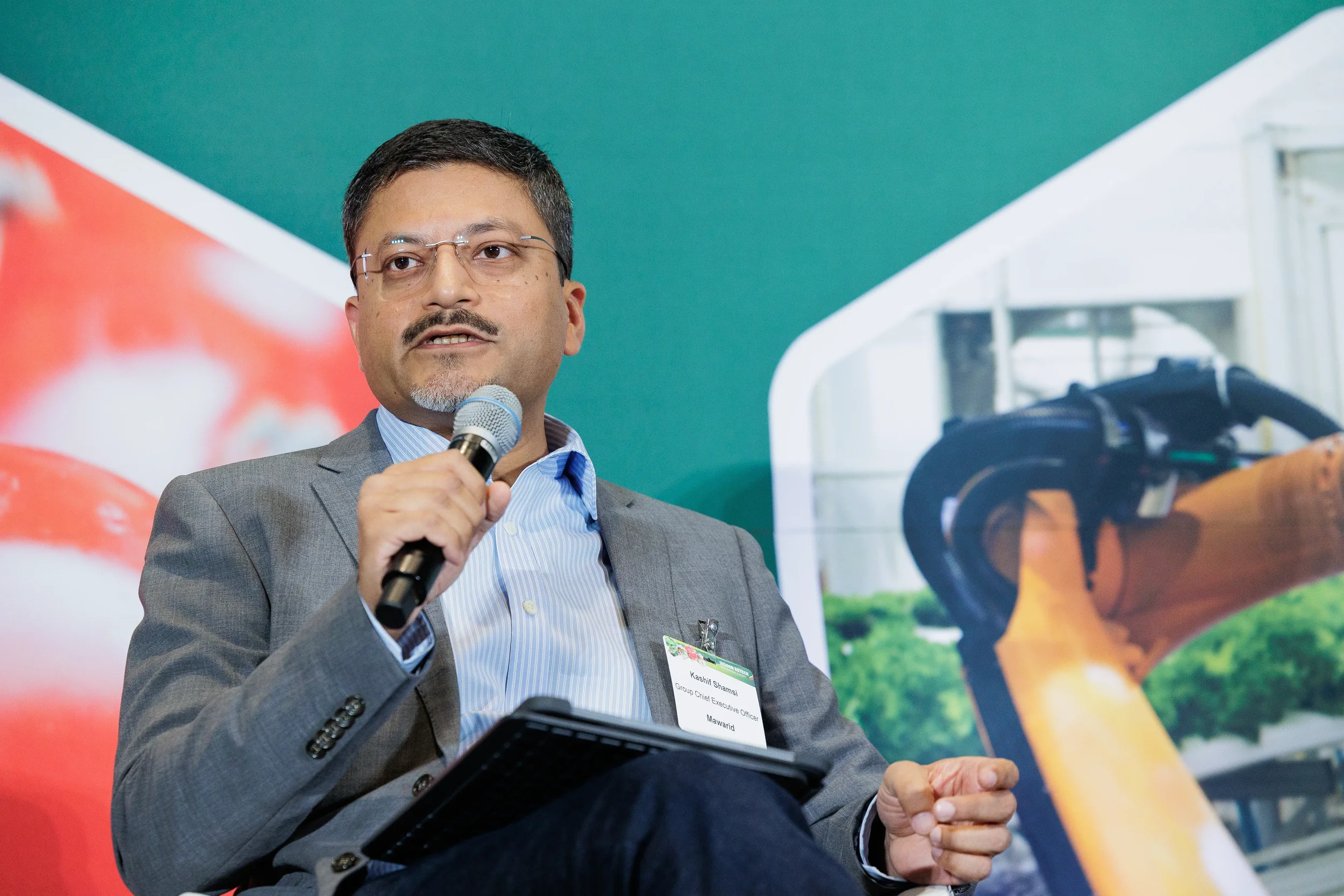 Panelist speaks into microphone during panel discussion at Chicago industry conference