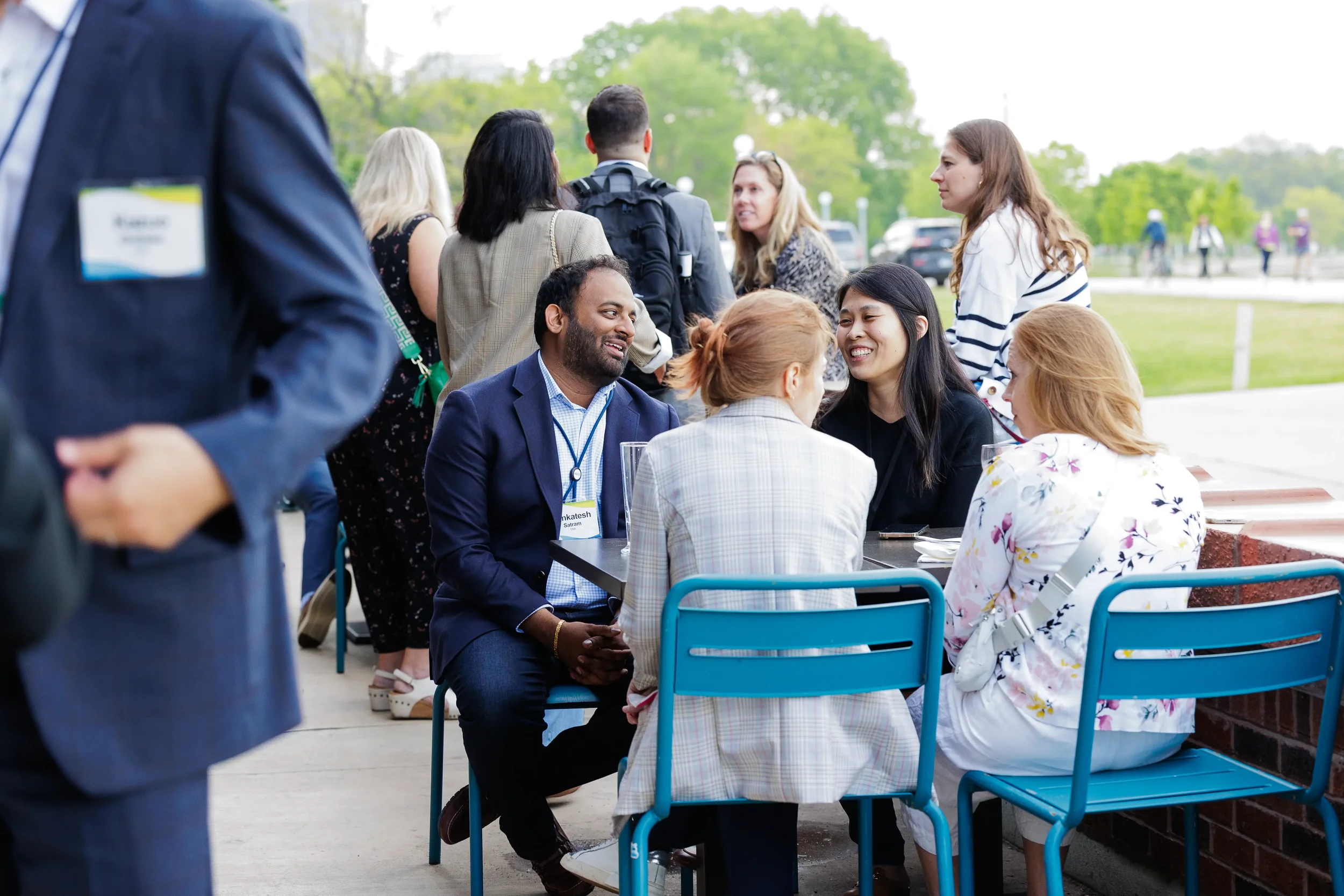 Attendees seated at outdoor table in conversation during Chicago corporate event