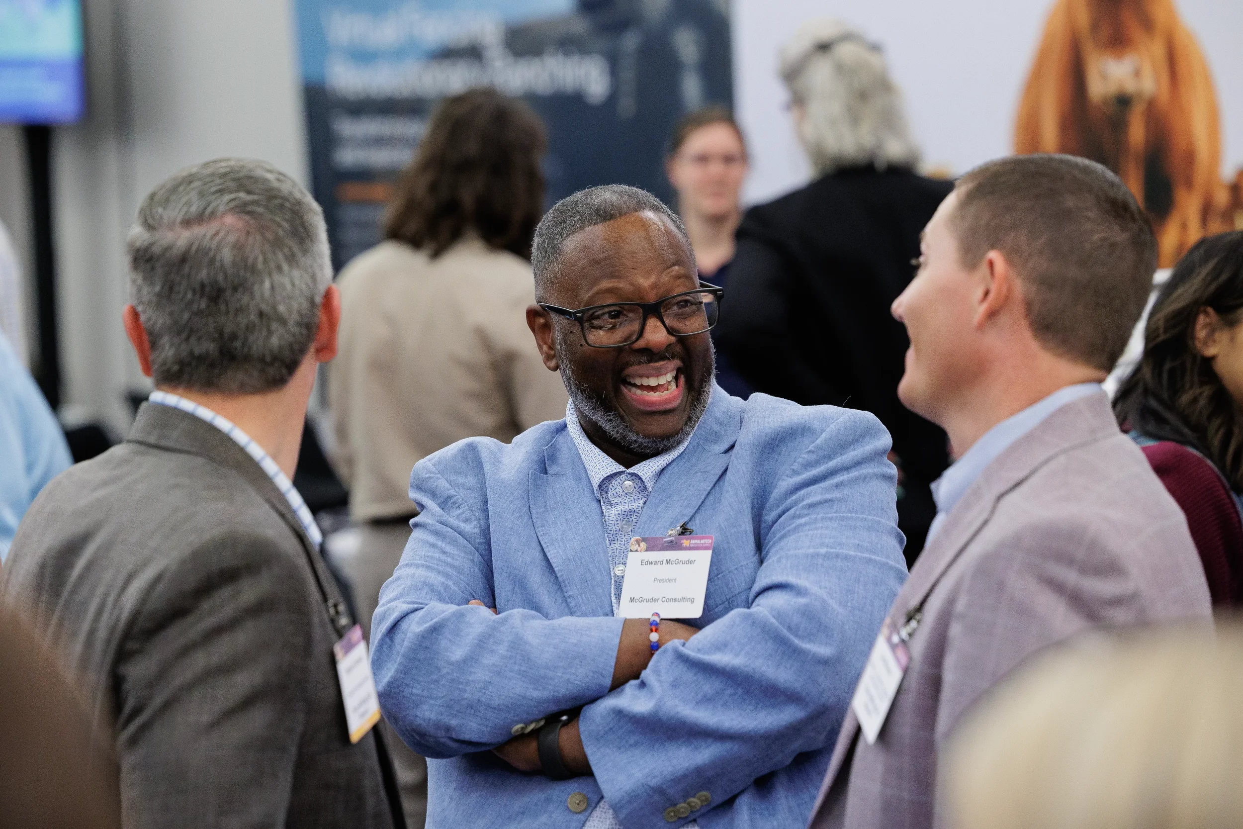 Attendees laugh and converse on expo floor during Orlando industry conference