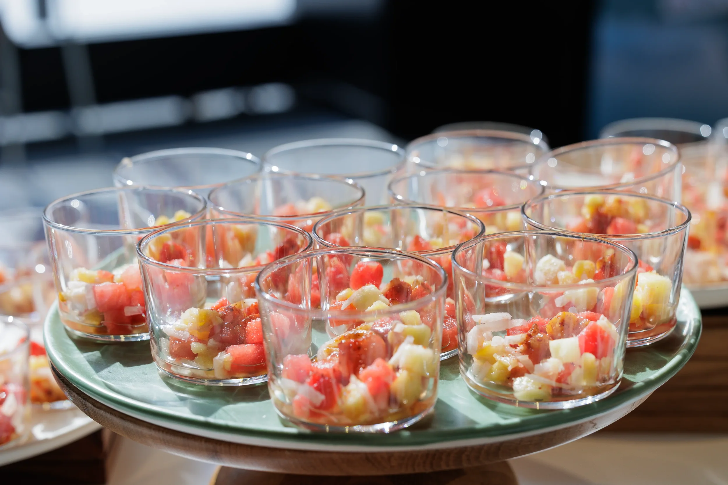 Rows of appetizer cups with shrimp and fruit displayed on tray at Chicago corporate event catering