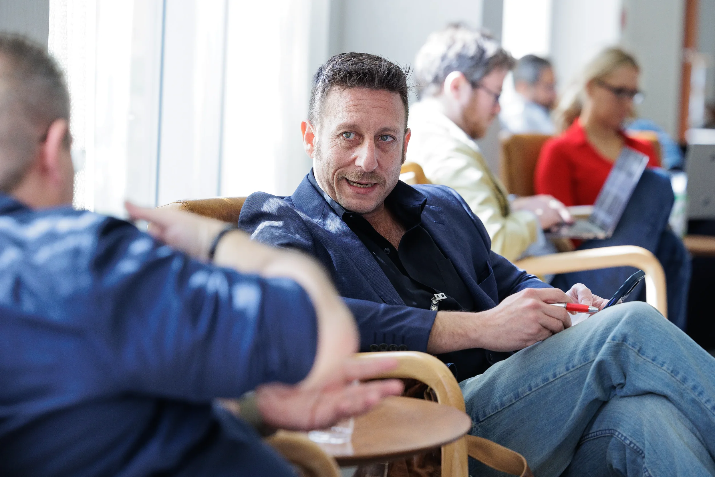 Attendee smiles during lounge conversation at Orlando corporate networking event