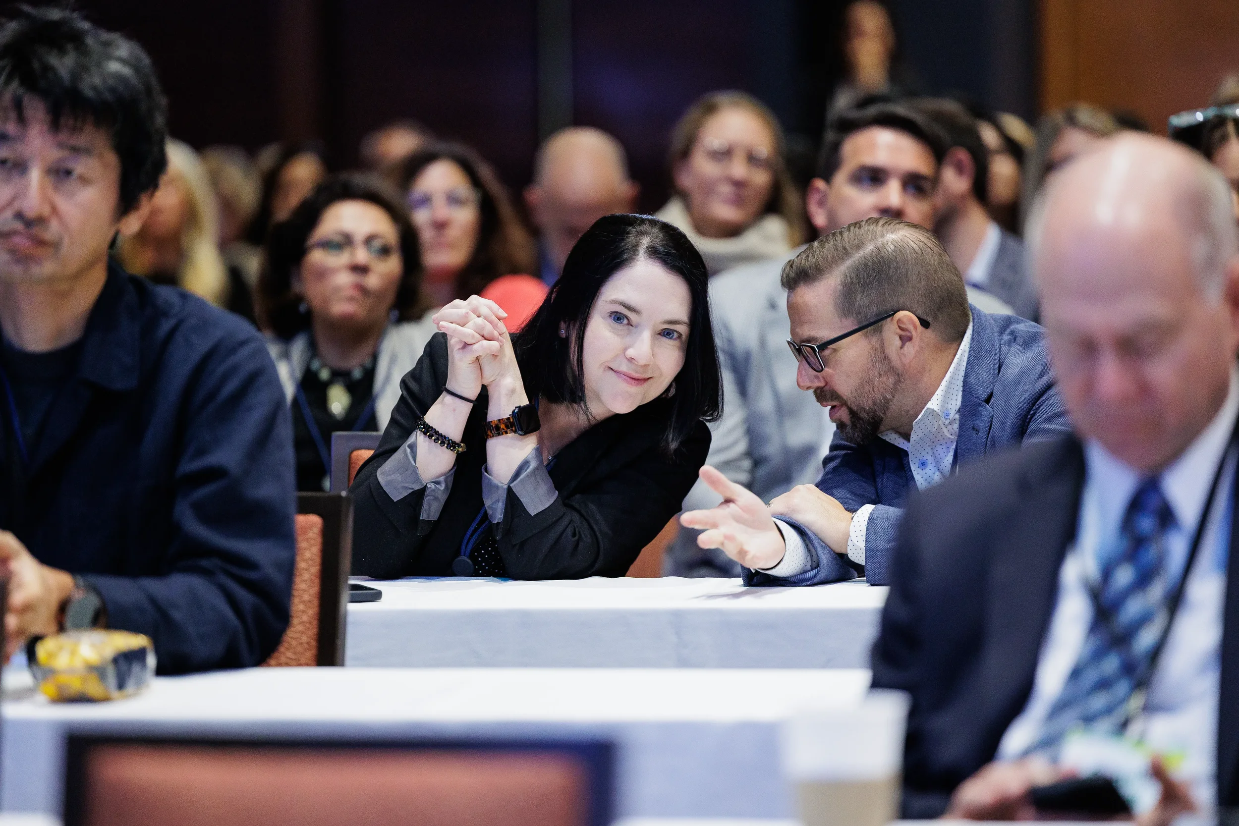 Attendees engage in conversation at seated table during Chicago industry conference