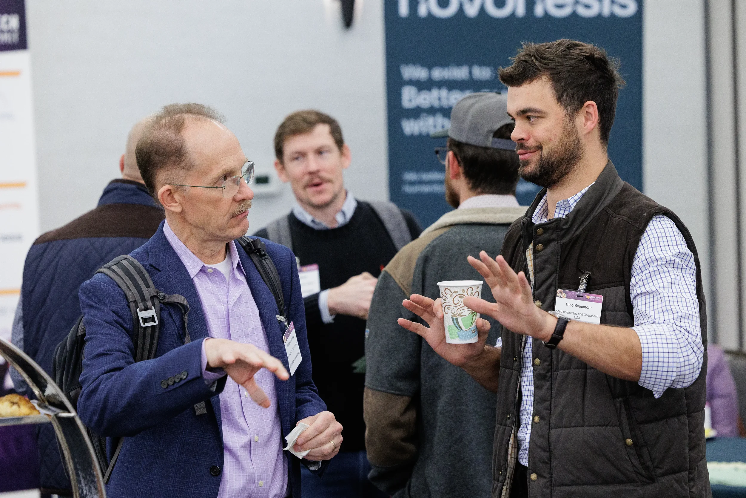 Attendees converse over coffee in expo hallway during Orlando industry conference
