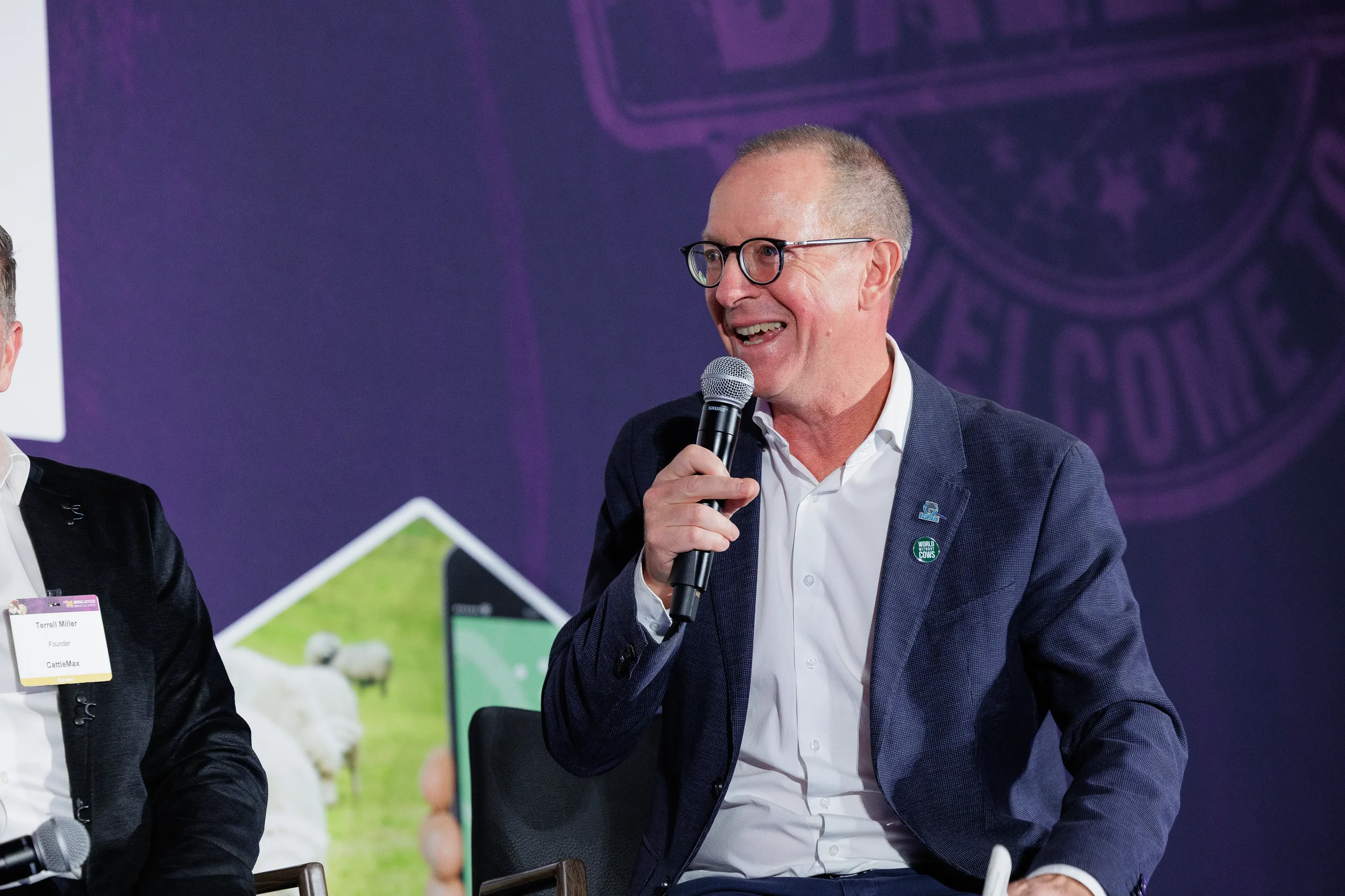 Panelist smiles while speaking into microphone at Orlando industry summit