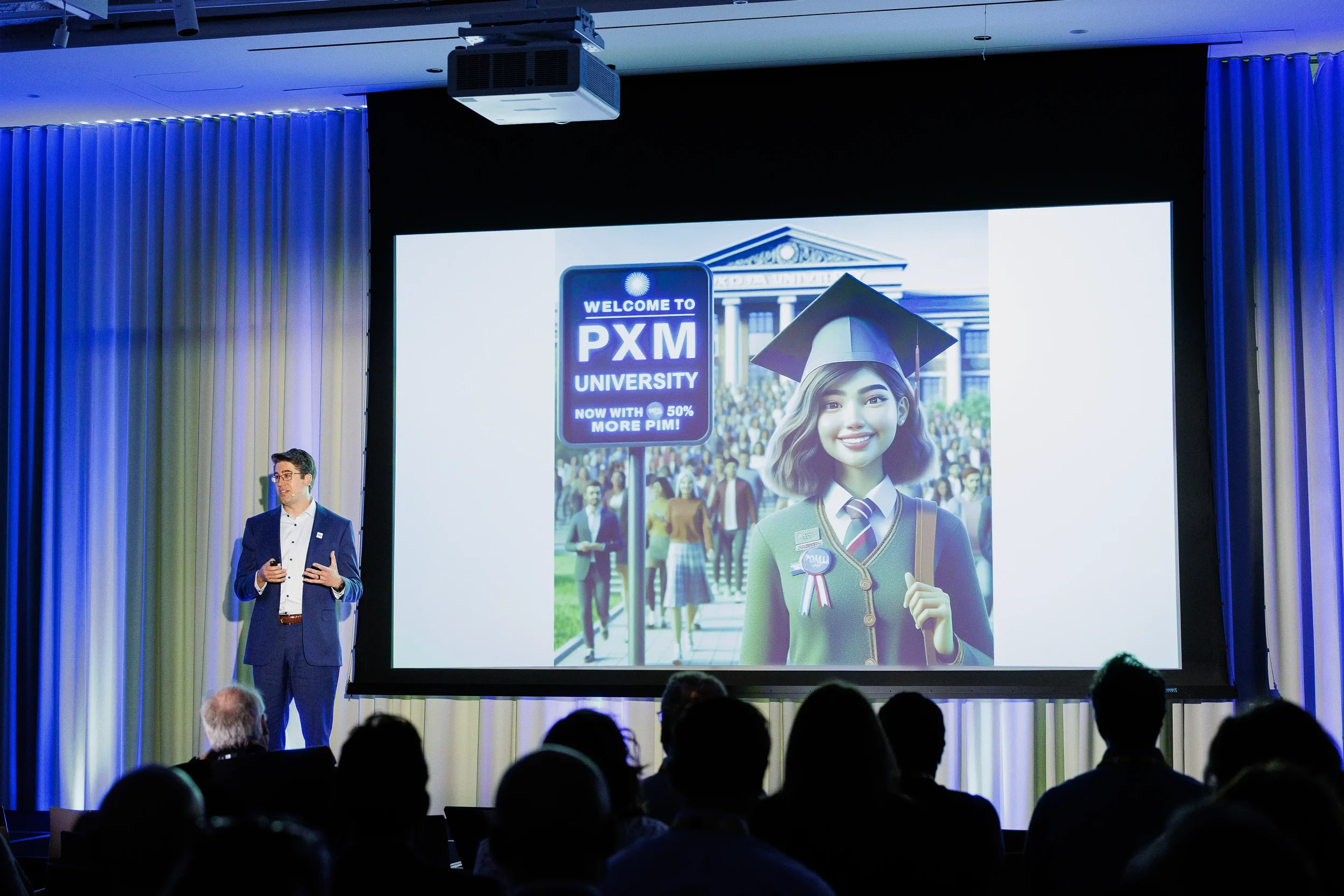 Presenter in blue suit speaks beside illustrated university slide on stage at Orlando industry conference