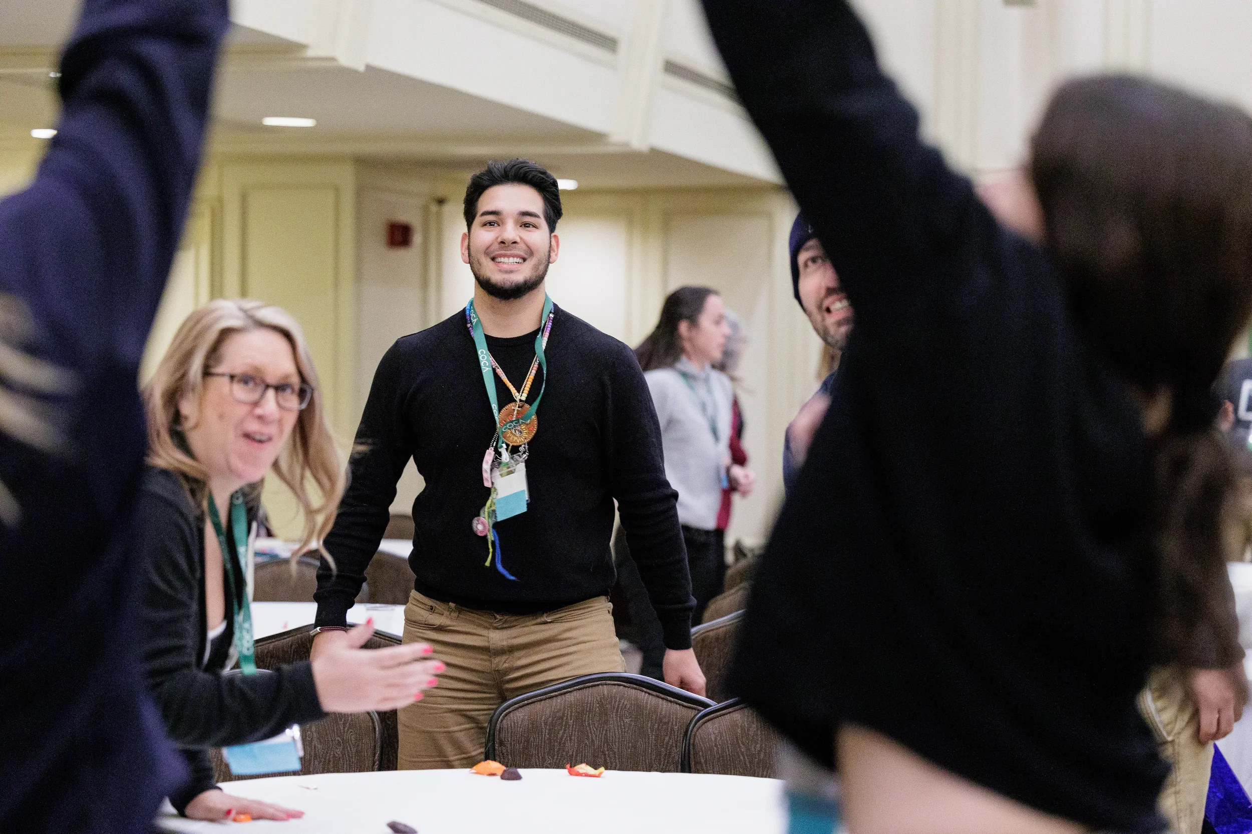 Attendees laugh and cheer during group activity at Chicago conference event