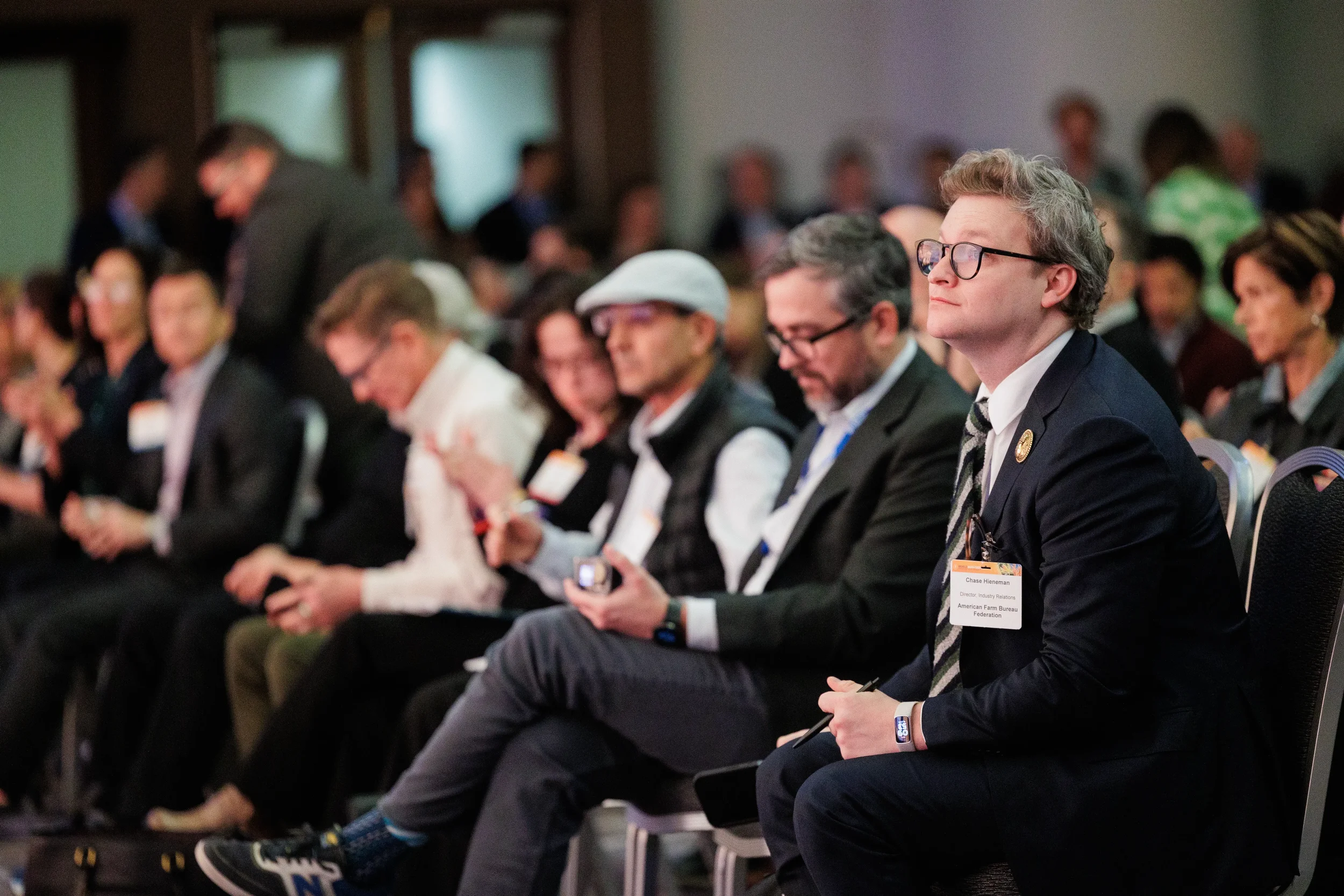 Row of badged attendees seated and listening attentively during session at Chicago corporate conference