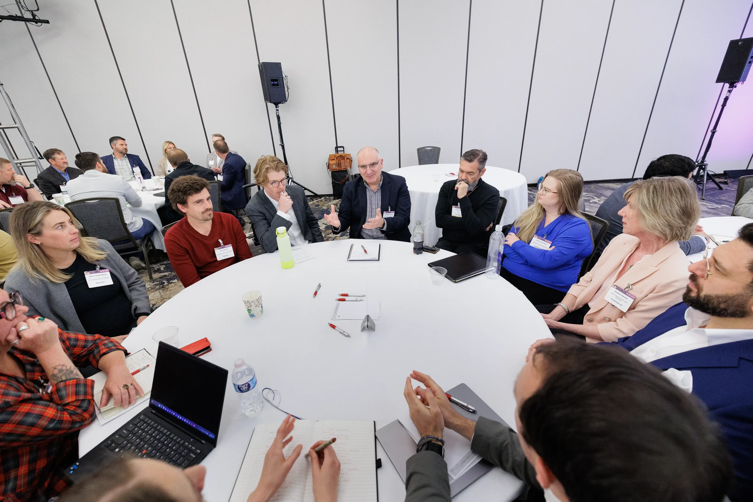 Overhead view of attendees in roundtable breakout discussion at Orlando industry conference