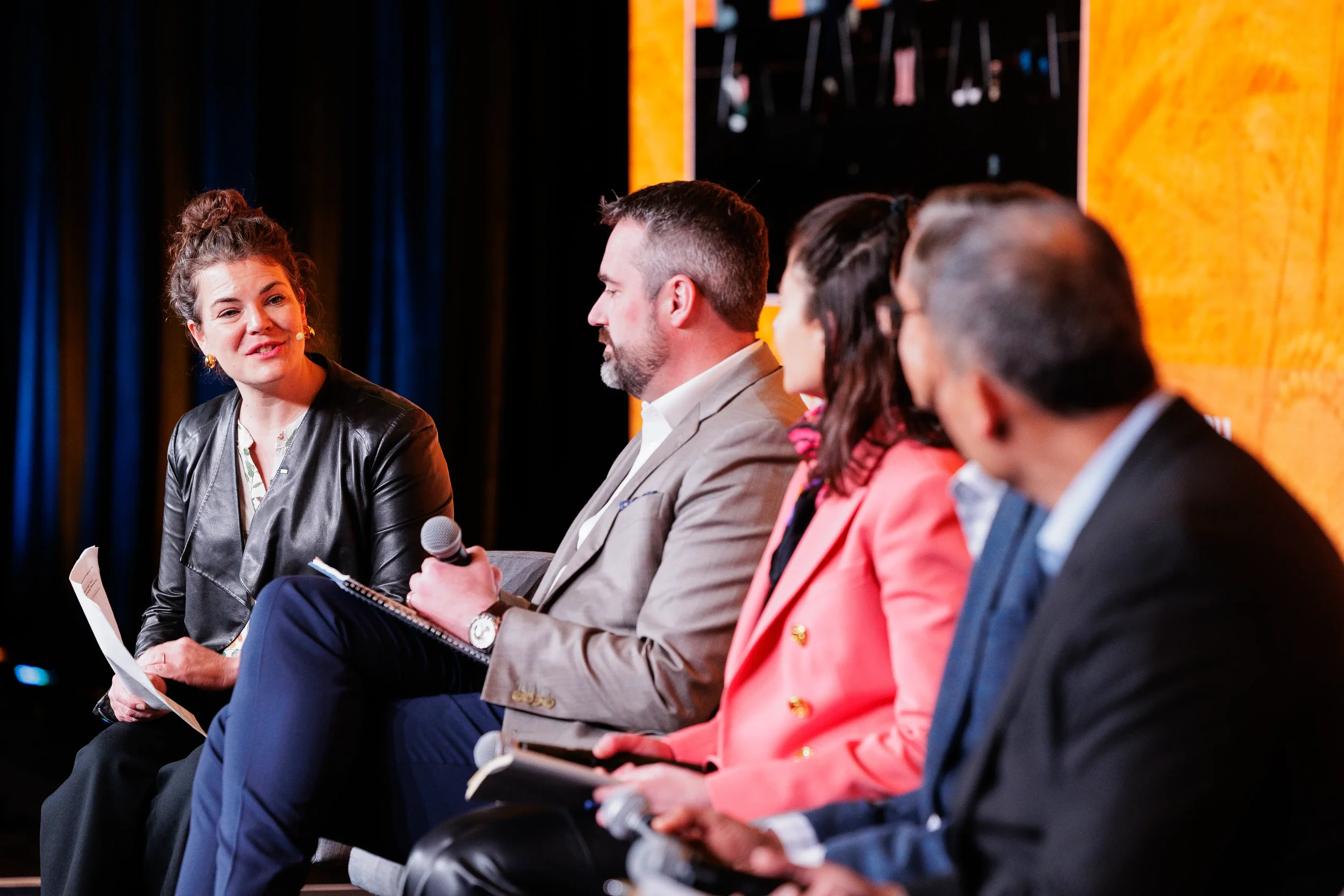 Panelists engage in discussion on stage during session at Chicago industry conference