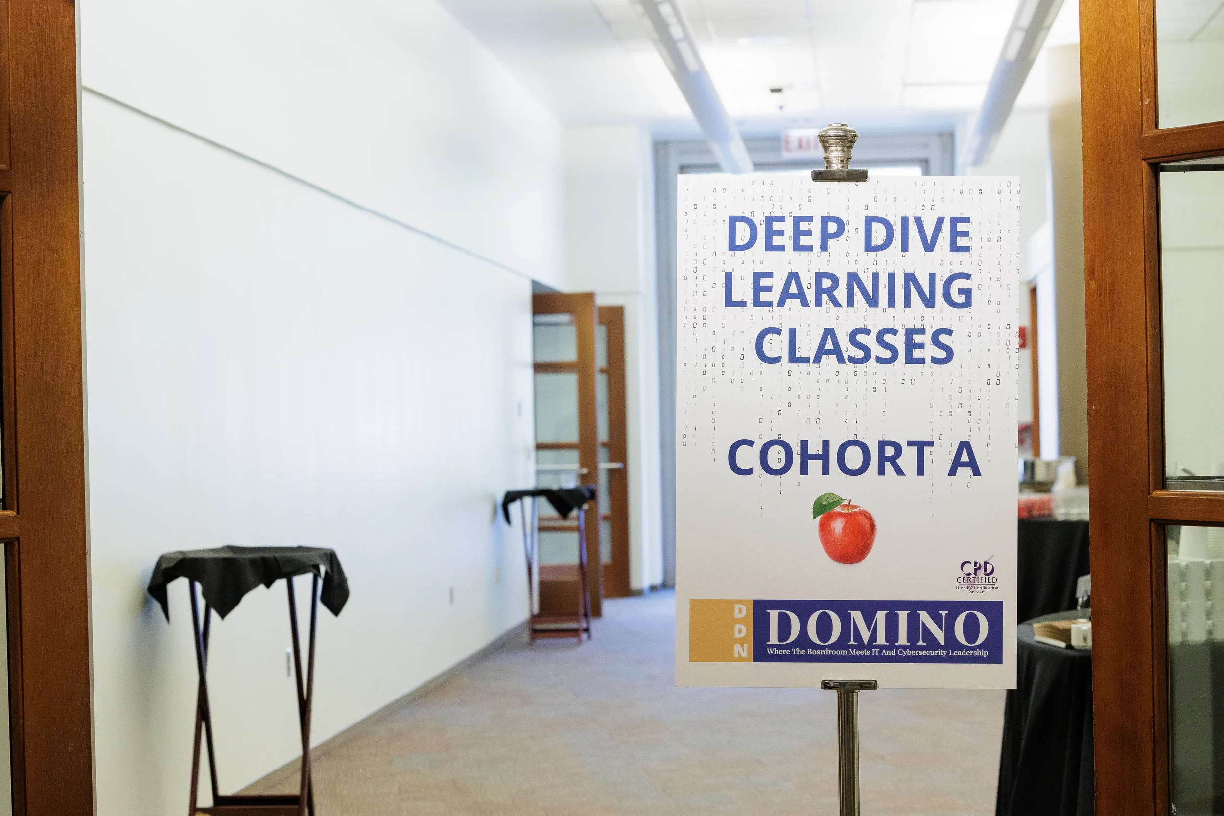 Branded session directional sign on easel in hallway at Chicago corporate conference venue