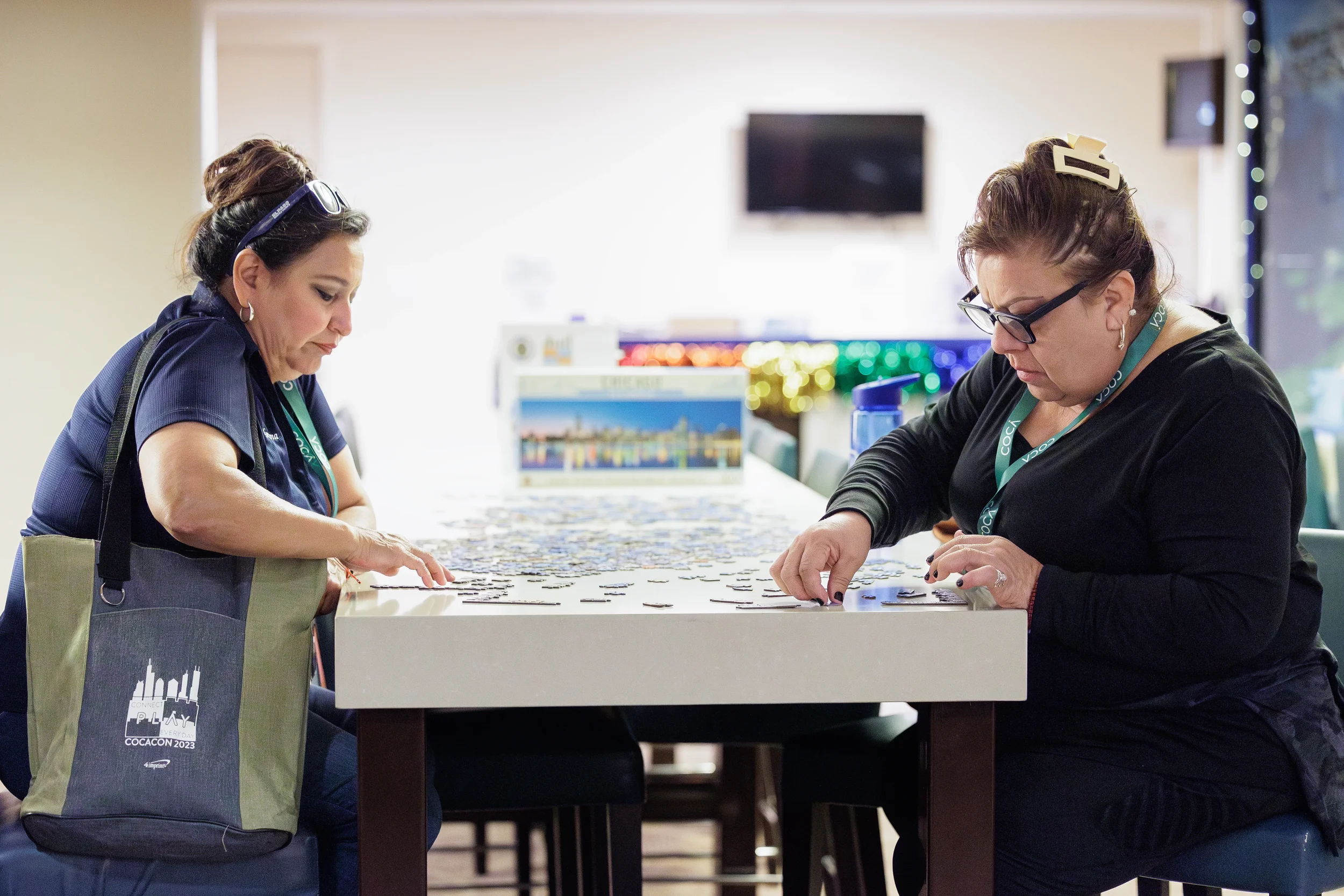 Two attendees work together on puzzle activity during team building session at Chicago event