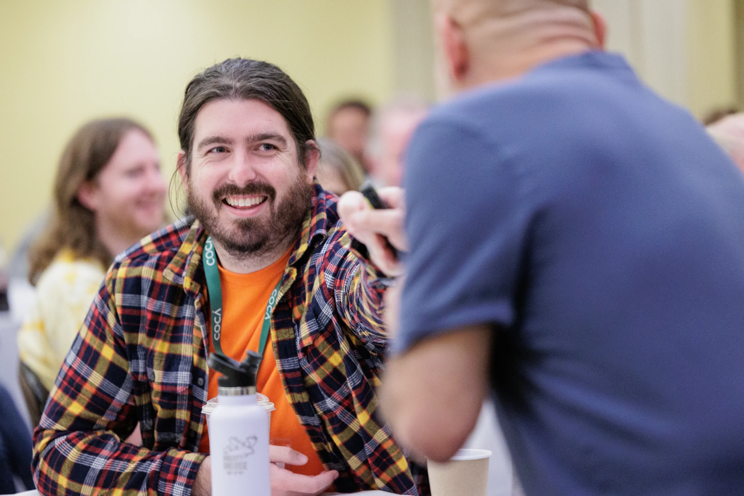 Attendee smiles during table conversation at Chicago conference event