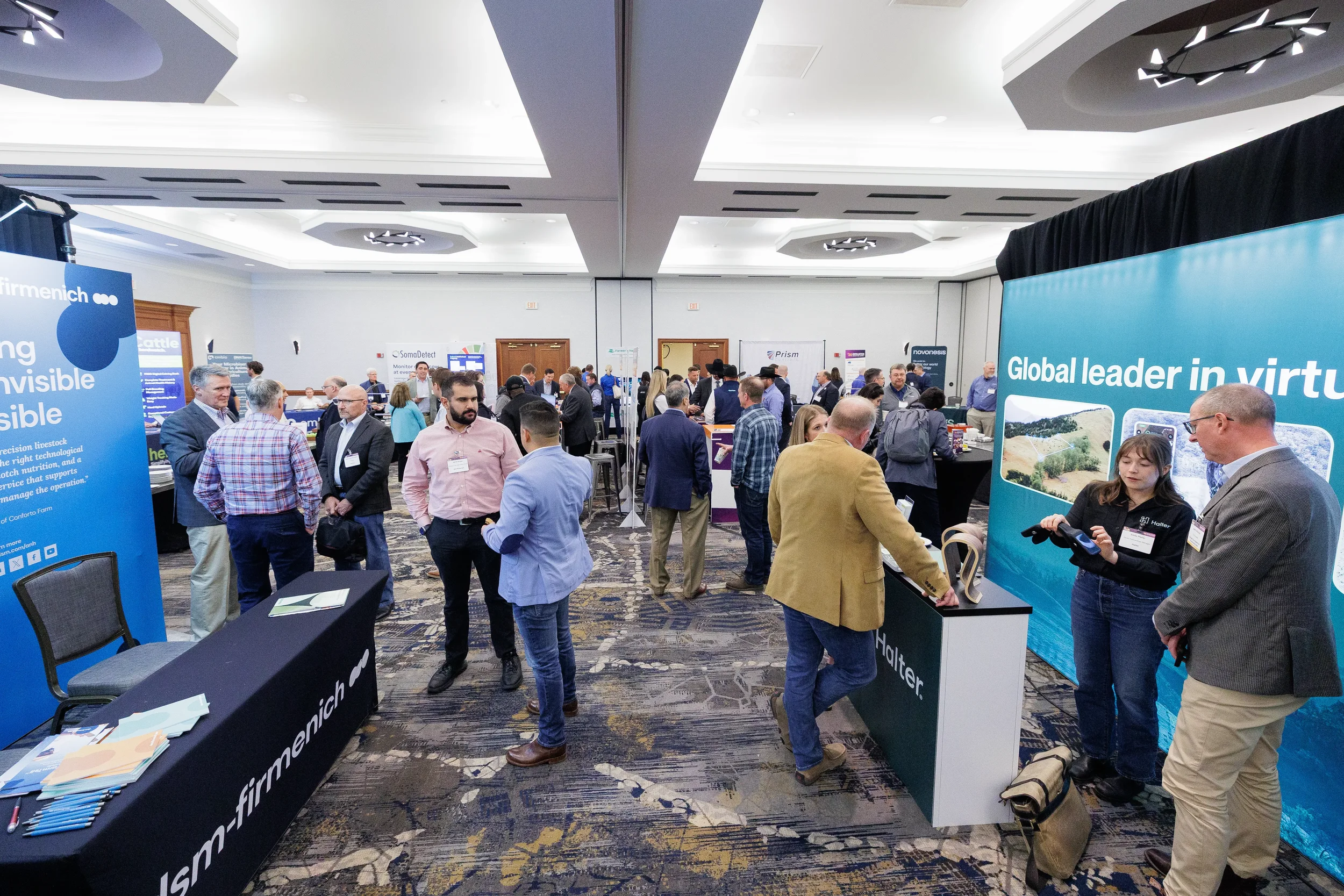 Wide view of attendees browsing expo hall booths during Orlando trade show