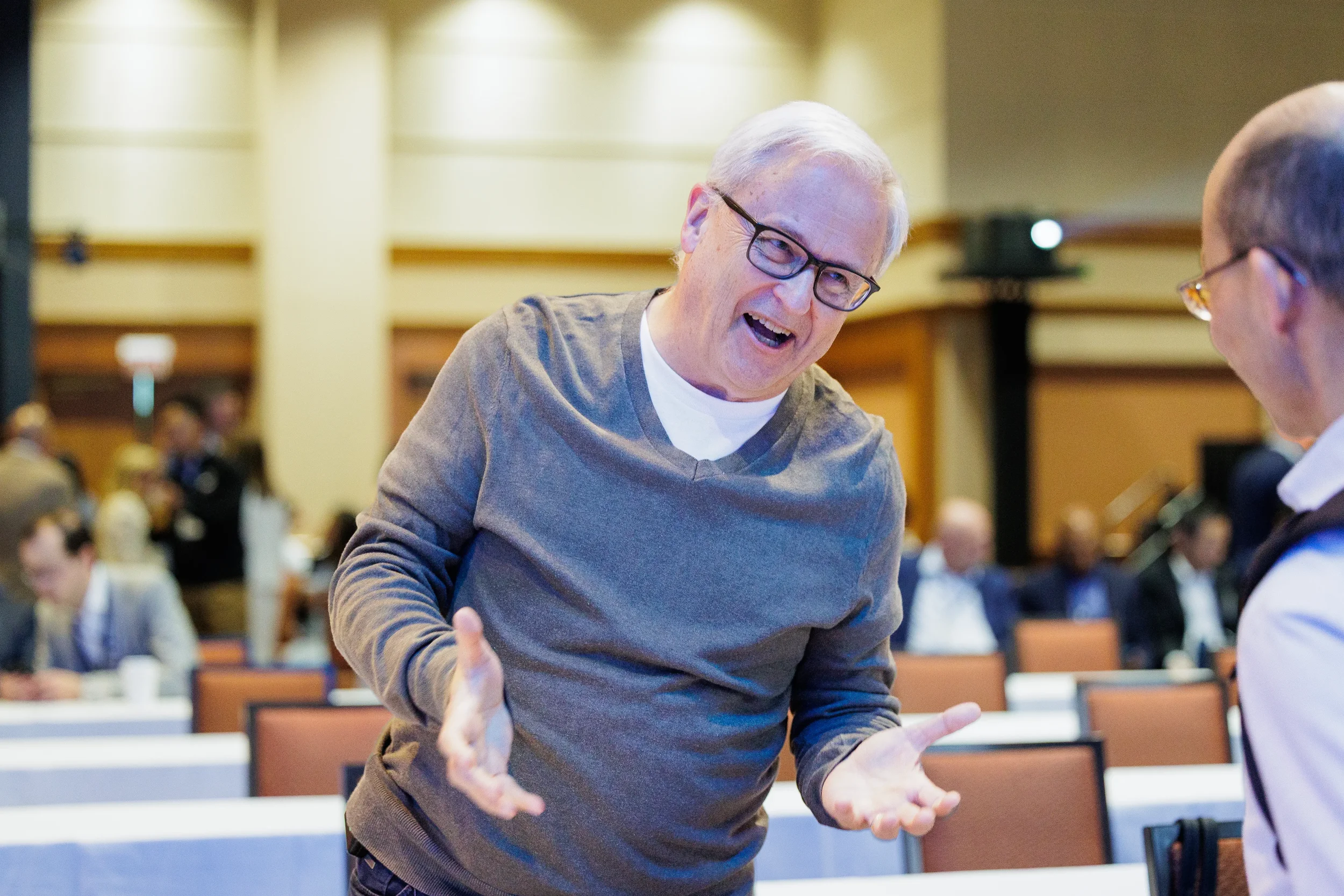 Attendee laughs and gestures while conversing at Orlando corporate conference