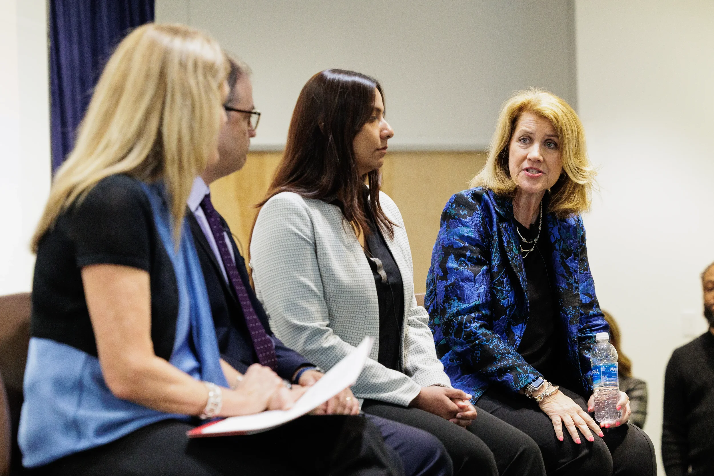 Four panelists seated in a row during panel discussion session at Chicago industry conference