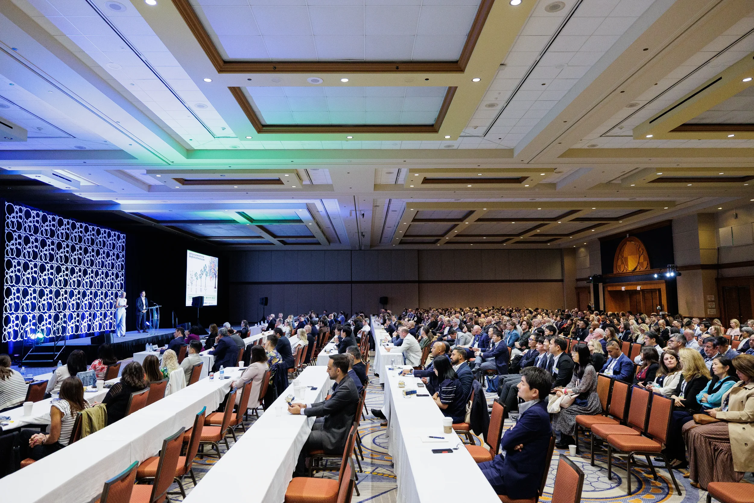 Large audience watches presentation during general session at Orlando industry conference