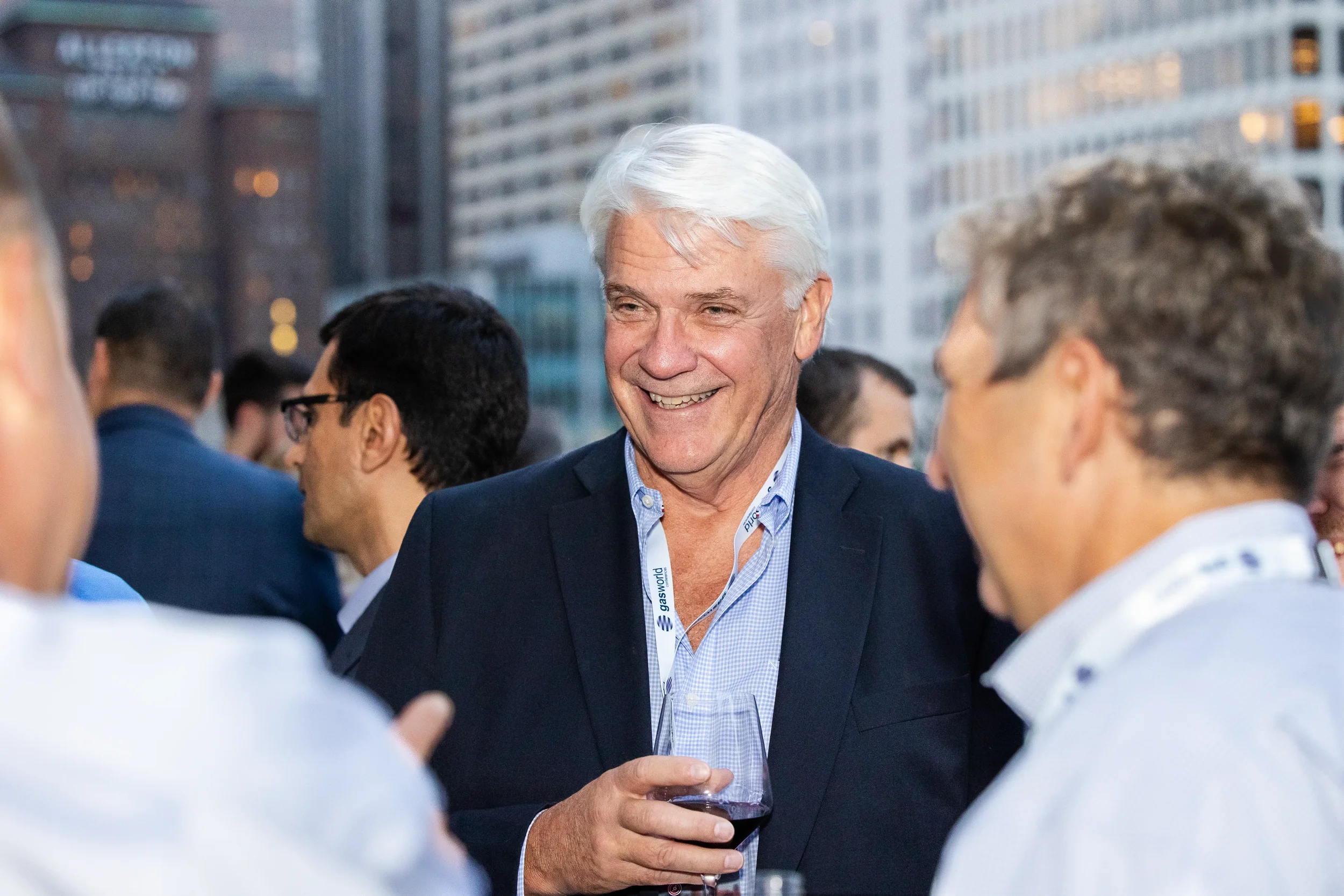 Conference attendee smiles while networking at rooftop reception during Orlando corporate event