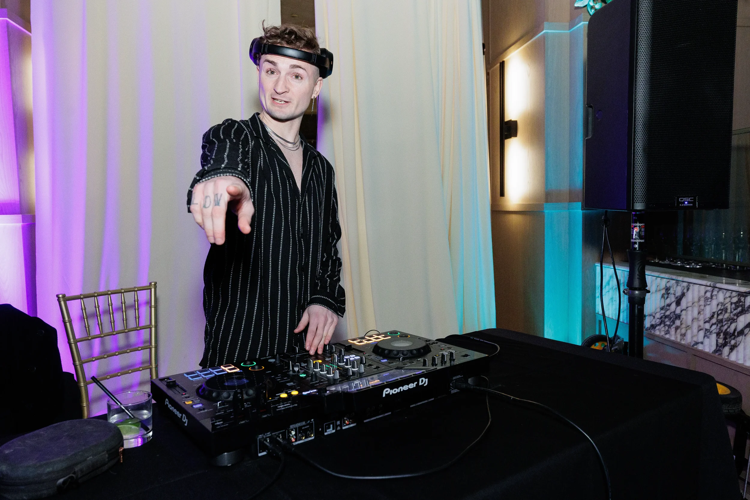 DJ performs at turntables during evening reception at Orlando corporate event venue