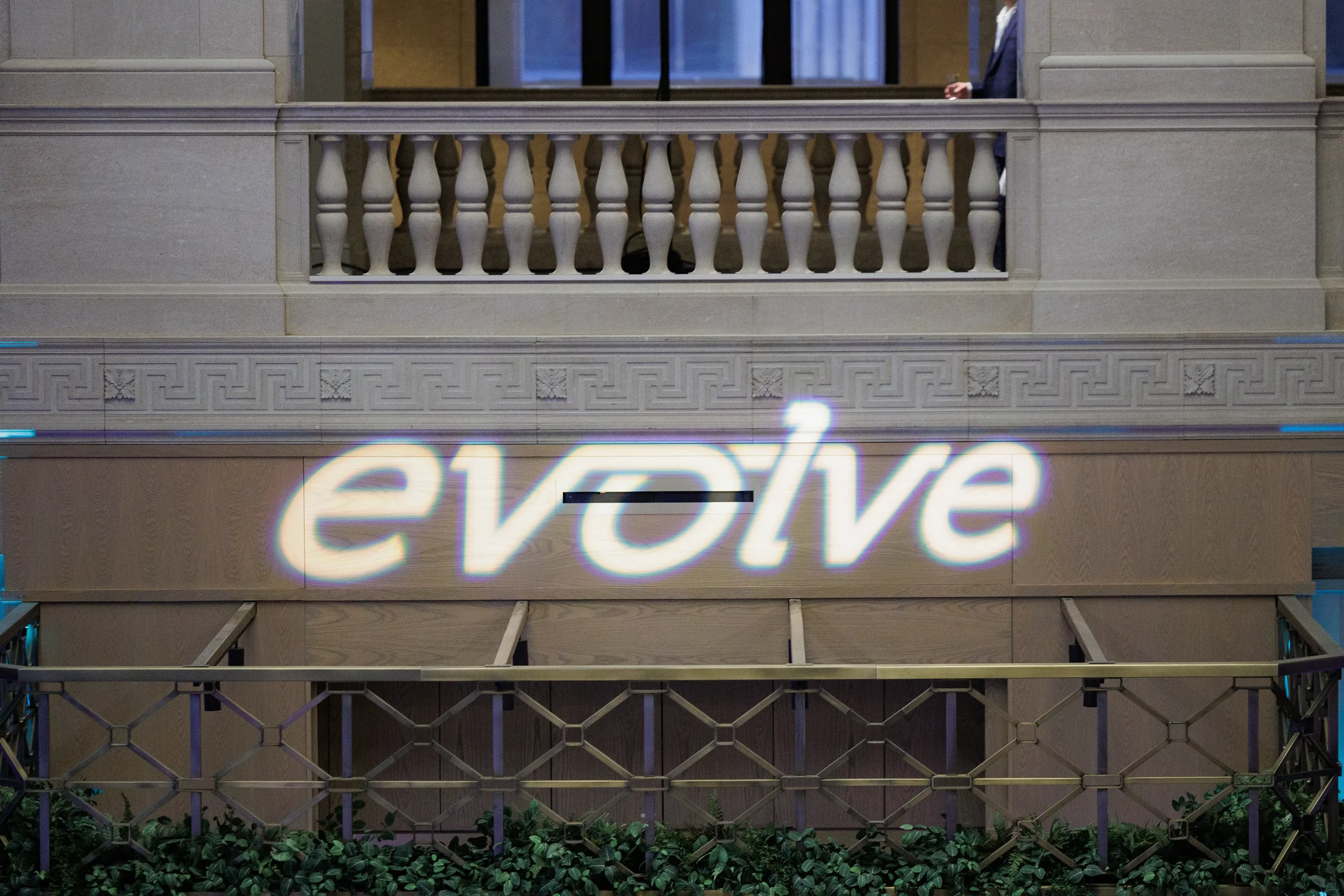 Brand logo projected in glowing light onto stone facade at Orlando corporate event venue