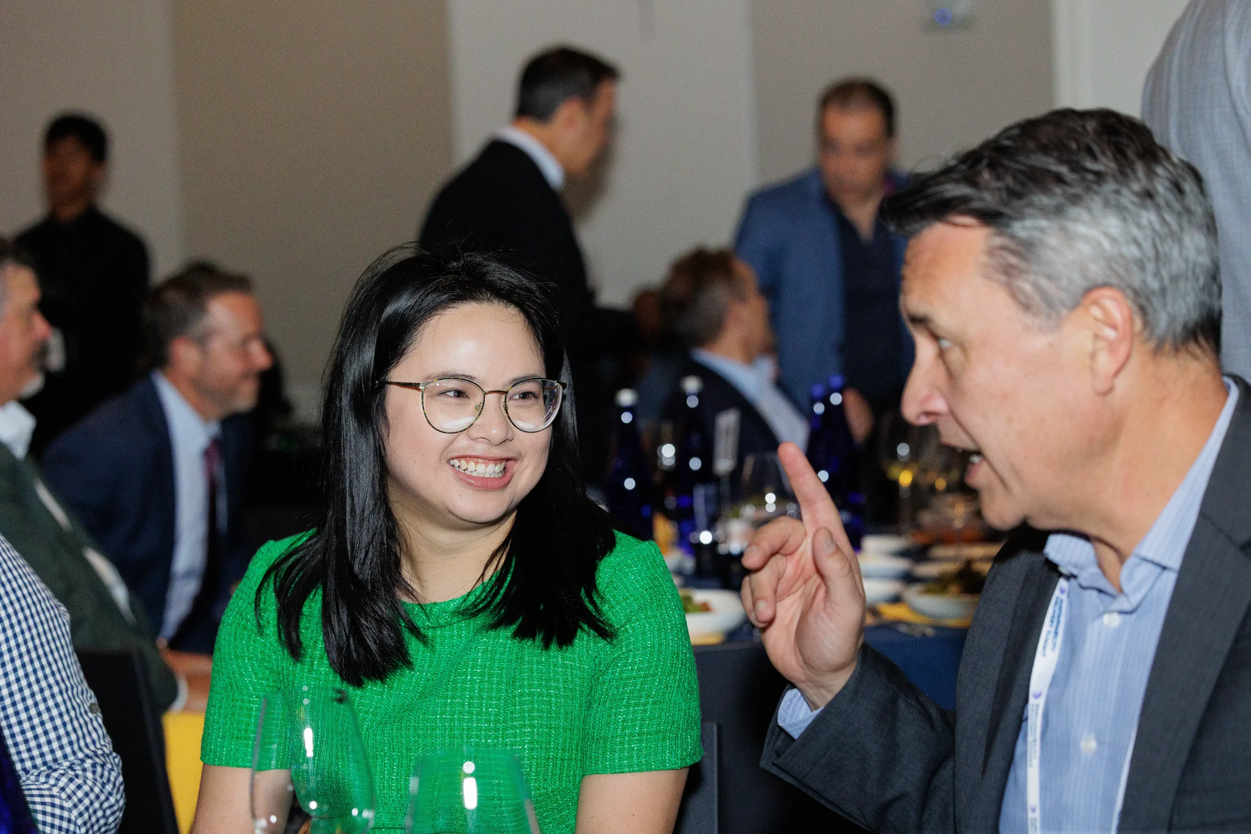 Attendees engage in animated conversation at dinner table during Orlando corporate event reception