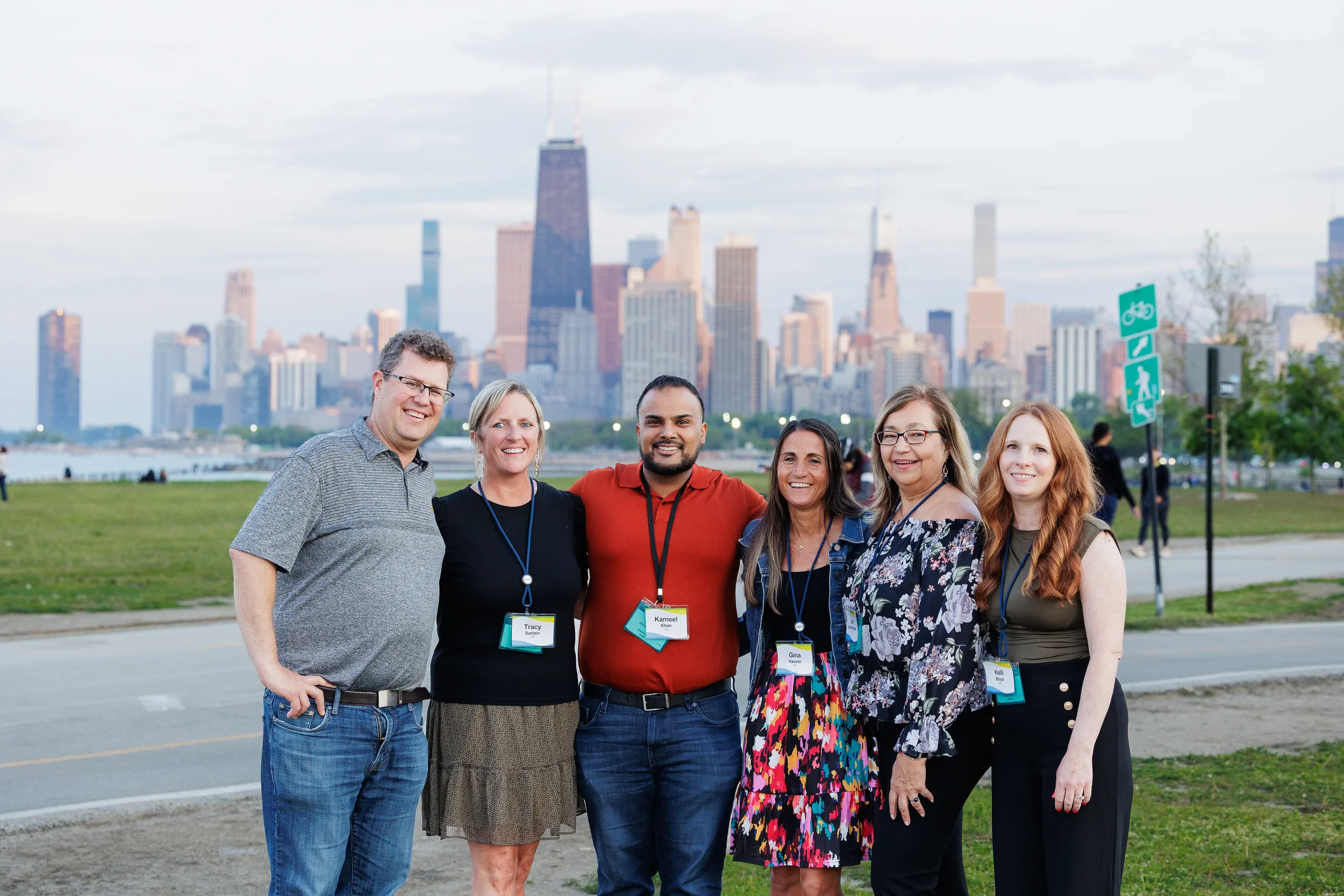 Six attendees pose together with Chicago skyline in background at industry networking event
