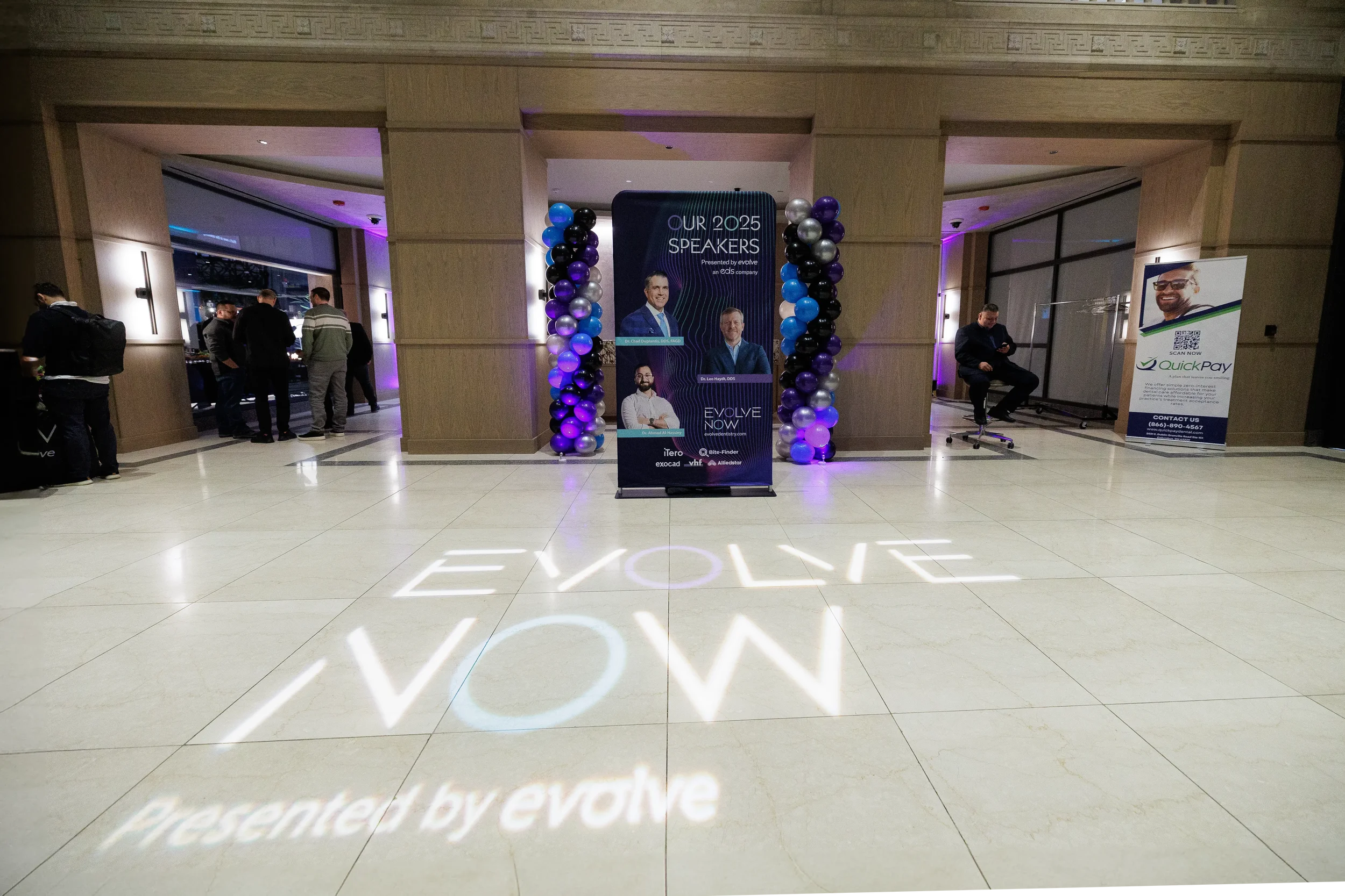 Speaker banner and branded floor projection welcome attendees at Orlando corporate event venue