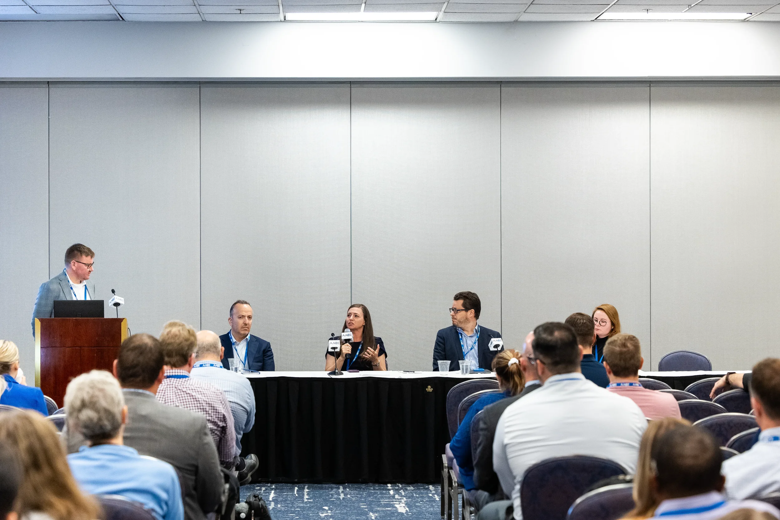Panelists engage in discussion during session with audience seated at Chicago corporate conference