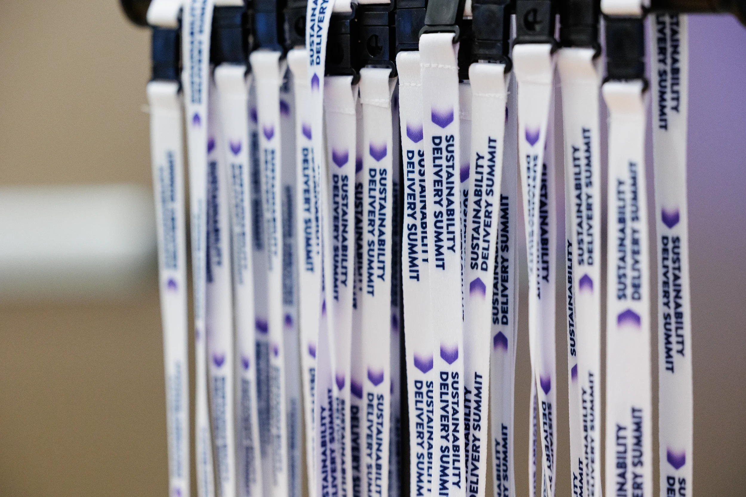 Rows of branded lanyards hang on display rack at Chicago corporate event registration