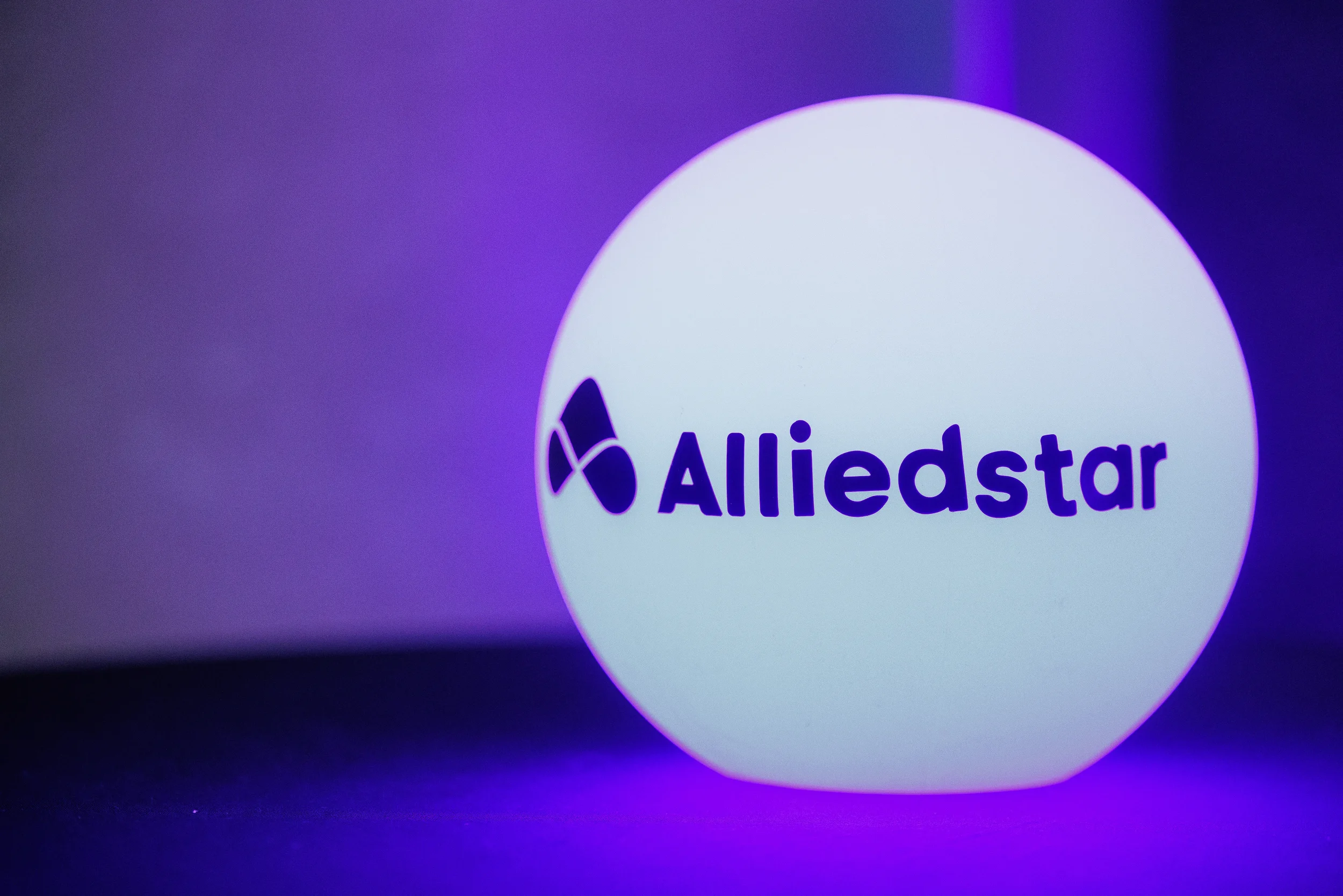Glowing illuminated sponsor orb with logo on display at Orlando corporate event