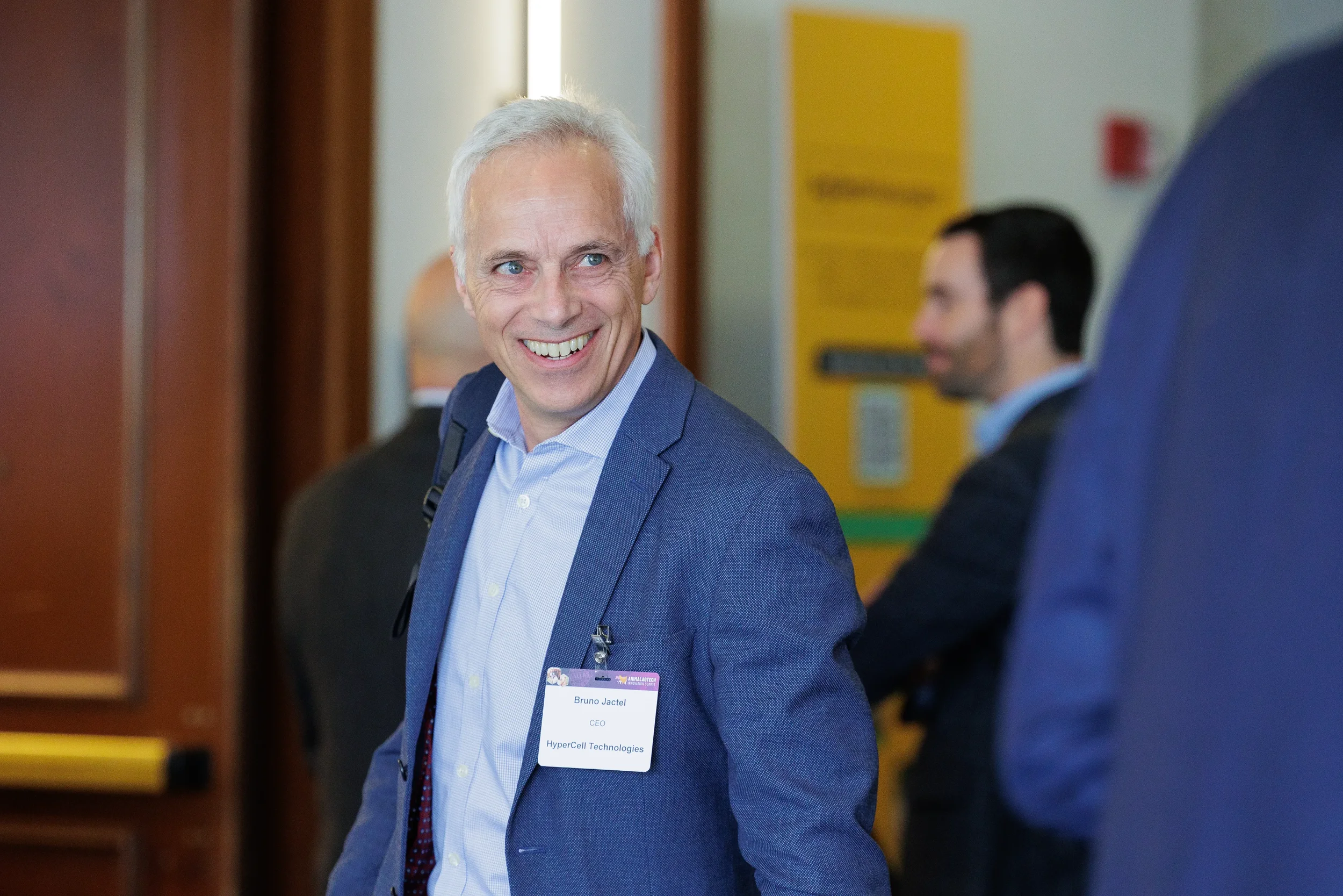 Attendee smiles while walking through hallway at Chicago corporate conference
