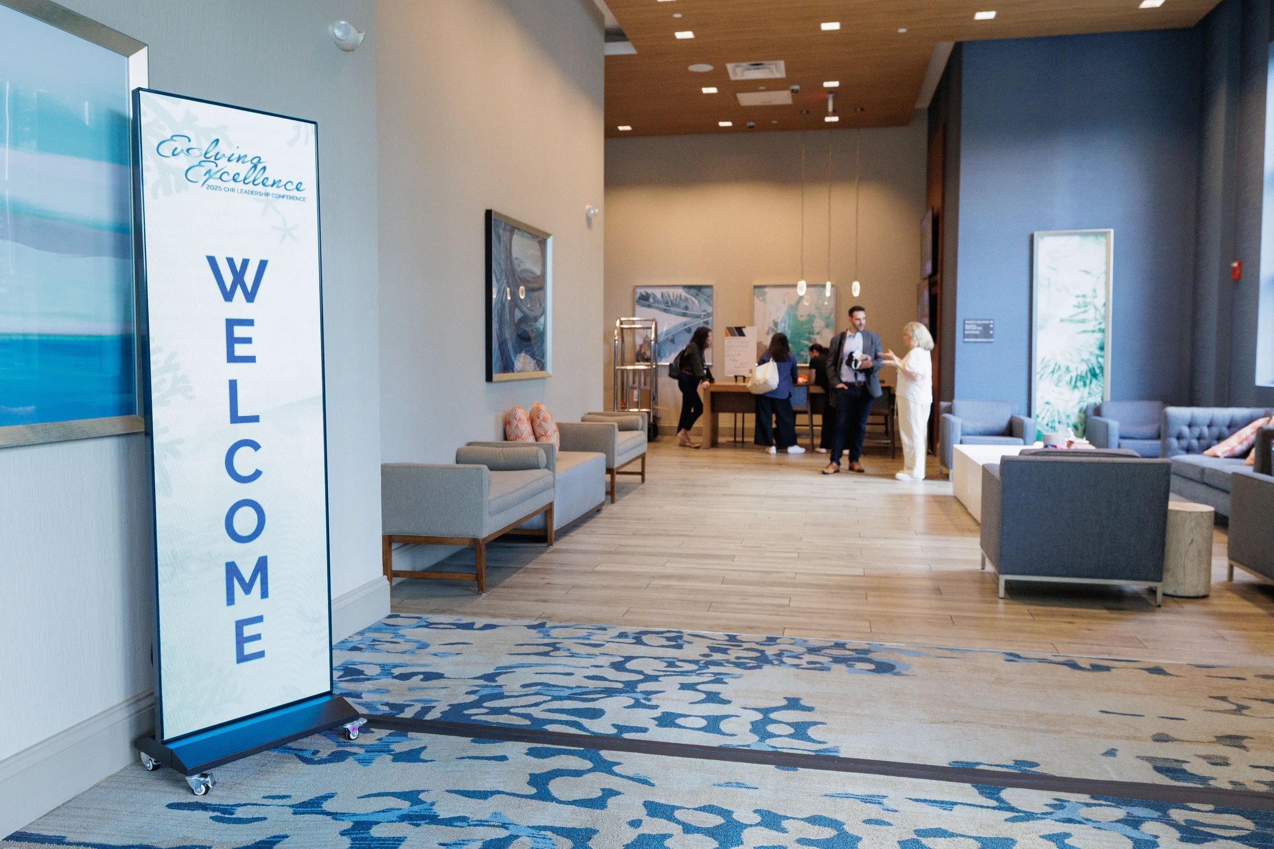 Branded welcome sign displayed in hotel lobby as attendees arrive at Orlando corporate conference