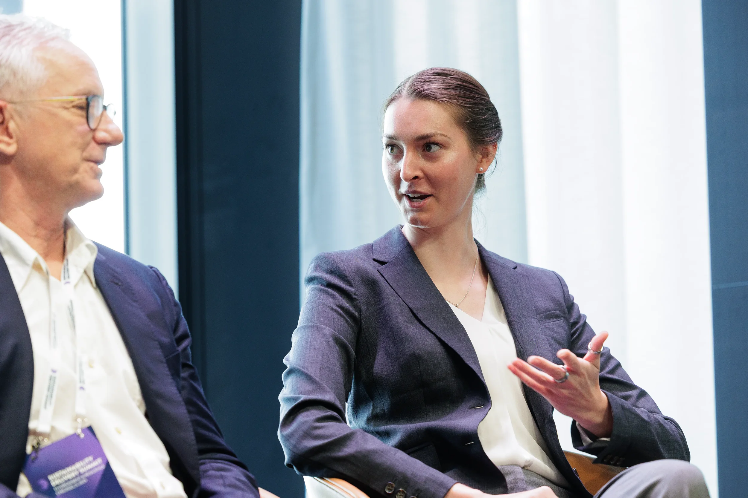 Panelist gestures while speaking during seated discussion at Chicago industry conference