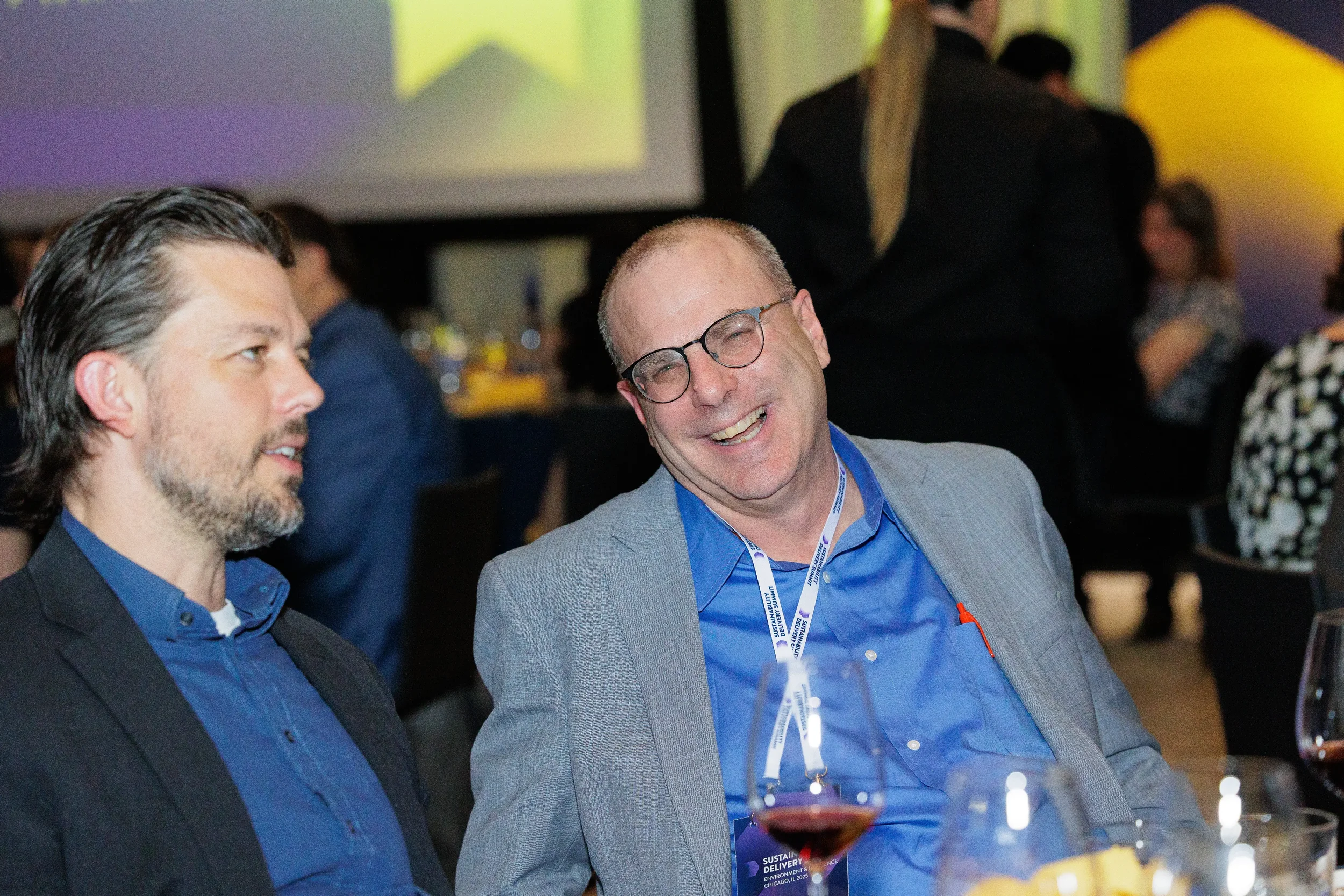 Attendees laugh and converse together during evening reception at Orlando corporate conference