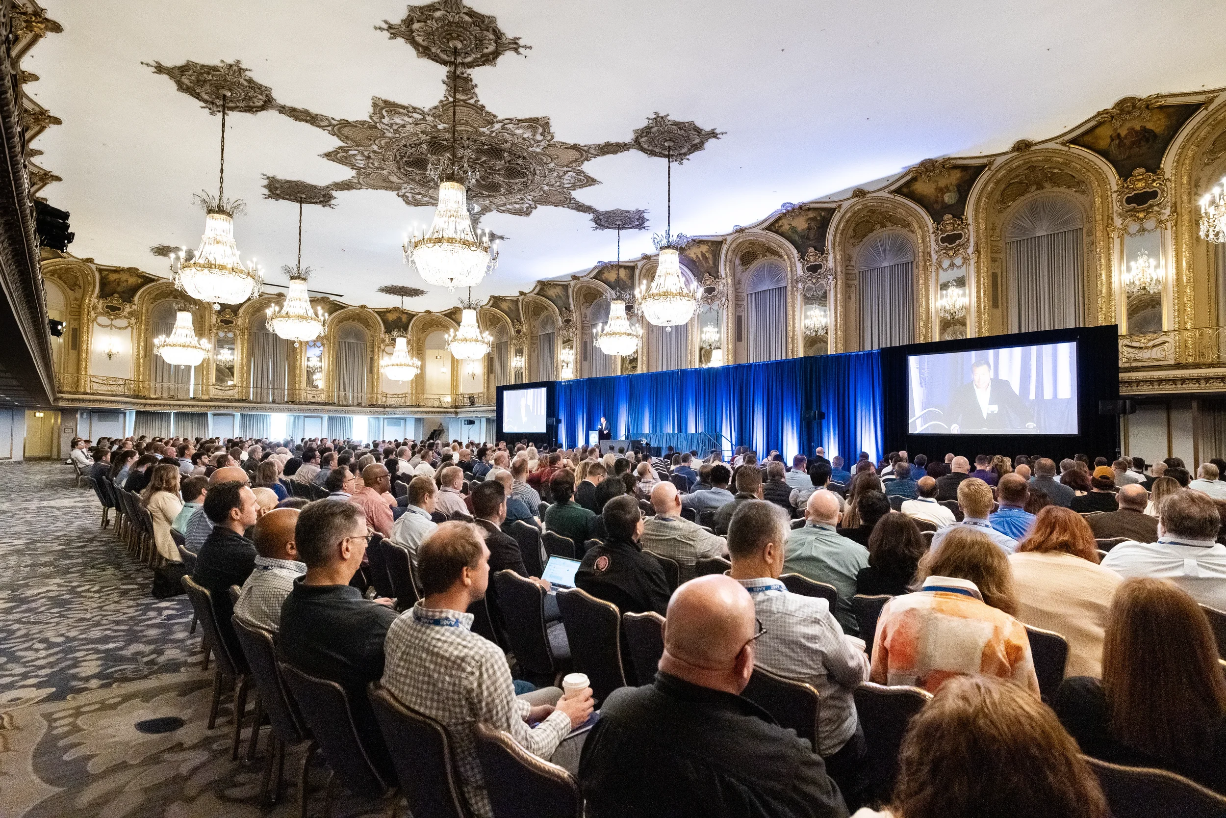 Packed ballroom of attendees watches keynote presentation at AACE International 2024 in Orlando