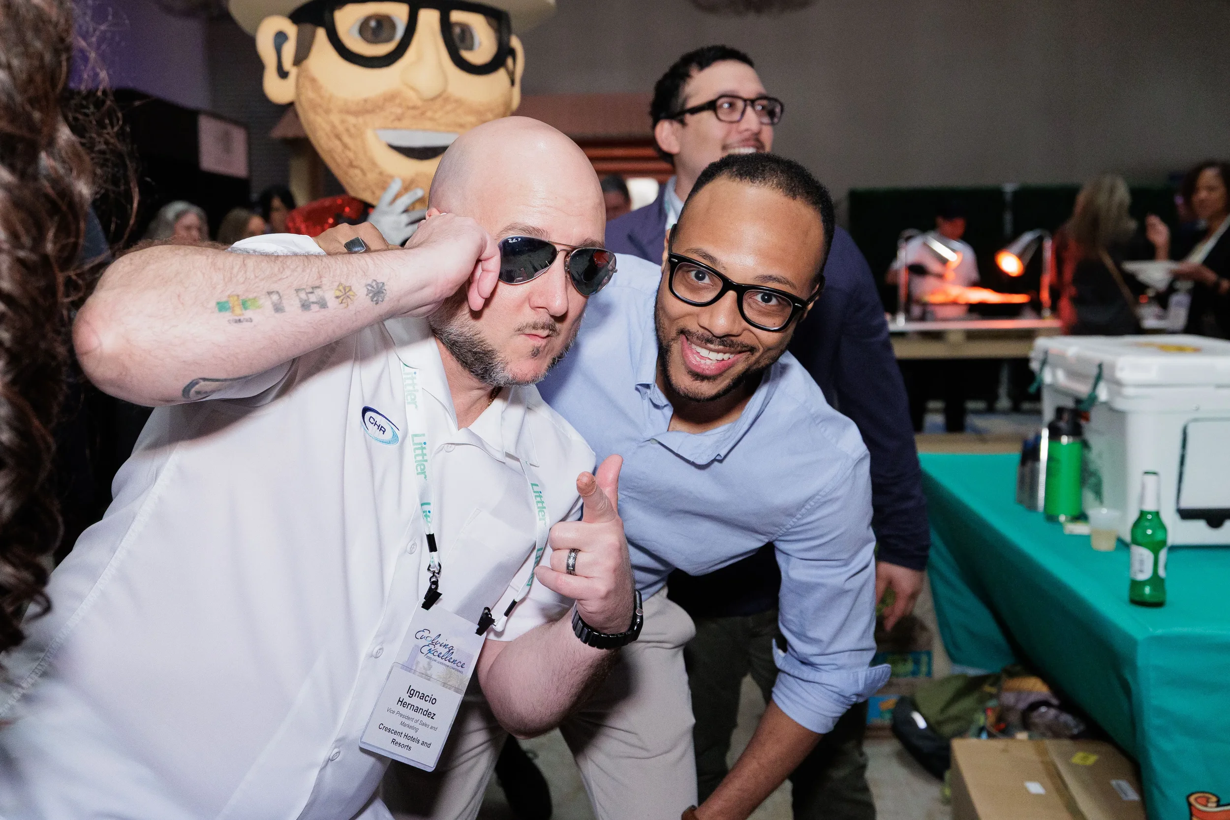 Two attendees pose playfully with costumed mascot character at Chicago corporate conference gala event