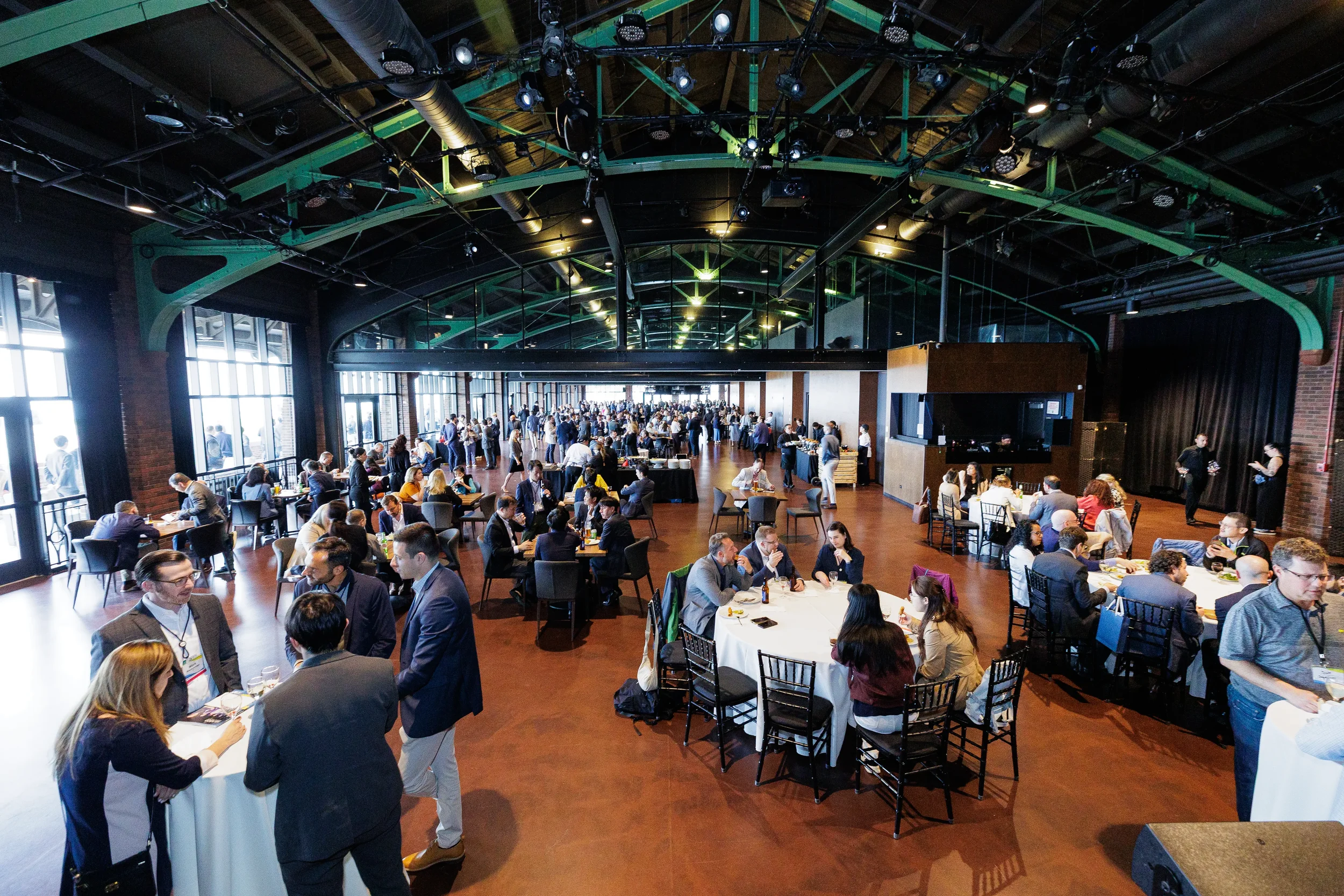 Wide view of attendees networking at reception venue during Orlando industry conference