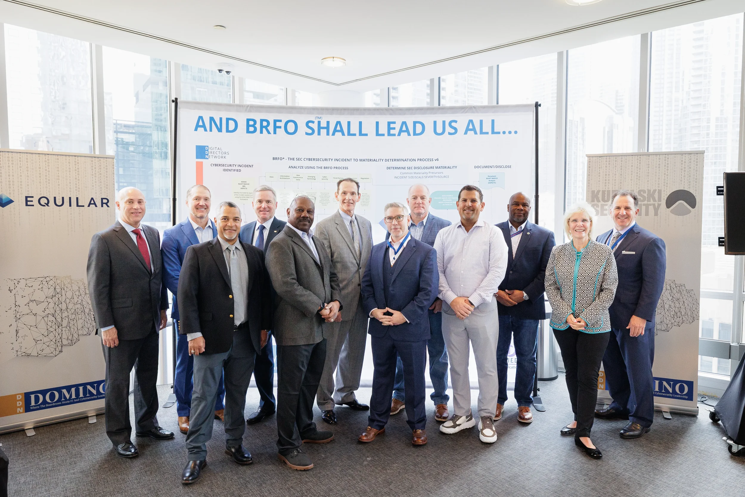 Large group of attendees with lanyards pose in front of branded diagram display at Orlando corporate event