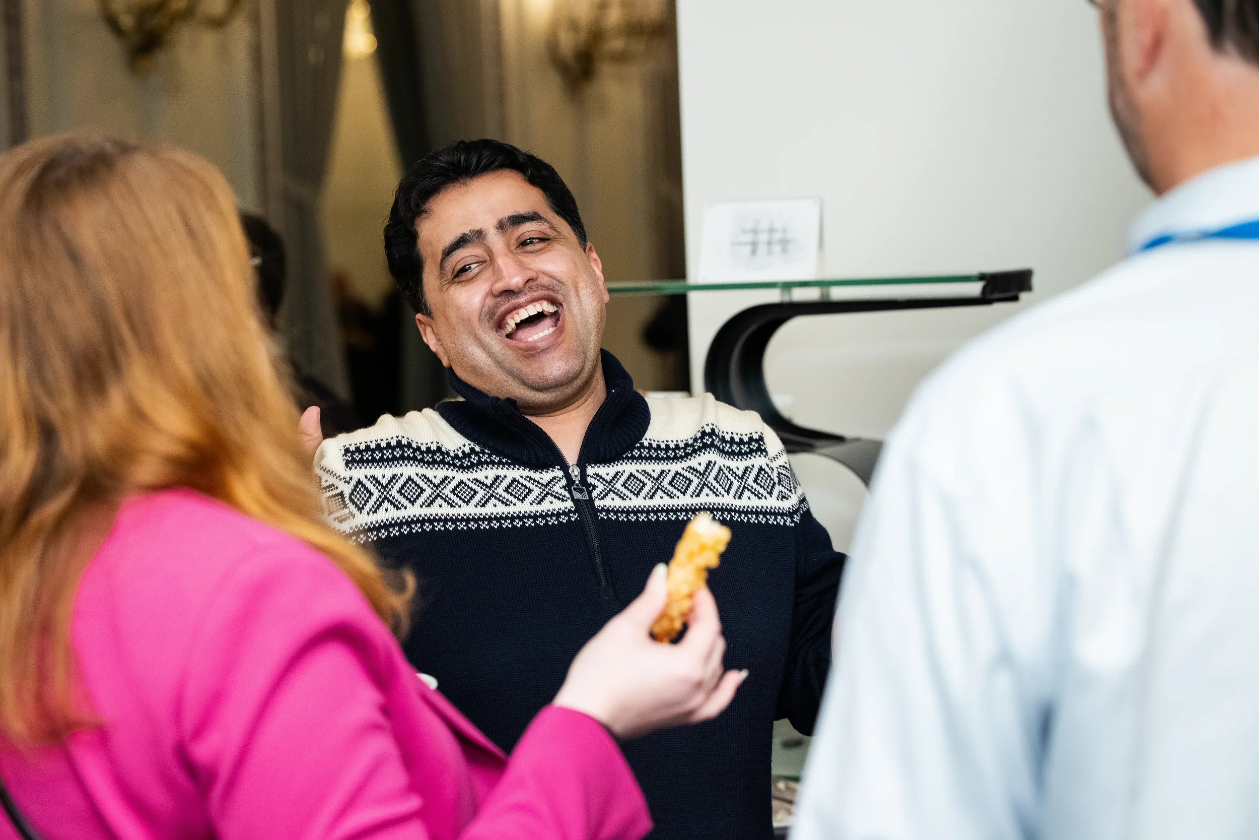 Conference attendee laughing during networking reception at Chicago corporate event