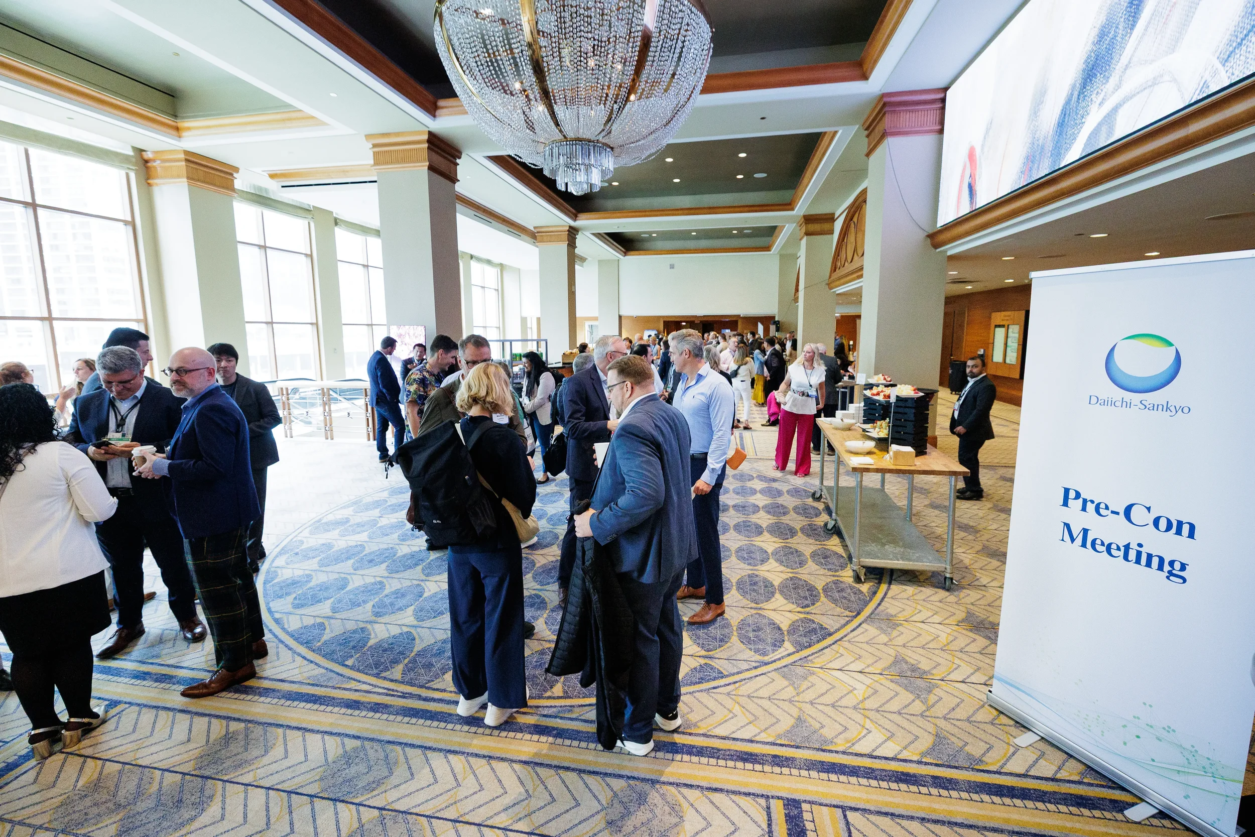 Attendees mingle and network in elegant hotel lobby during Orlando corporate event reception
