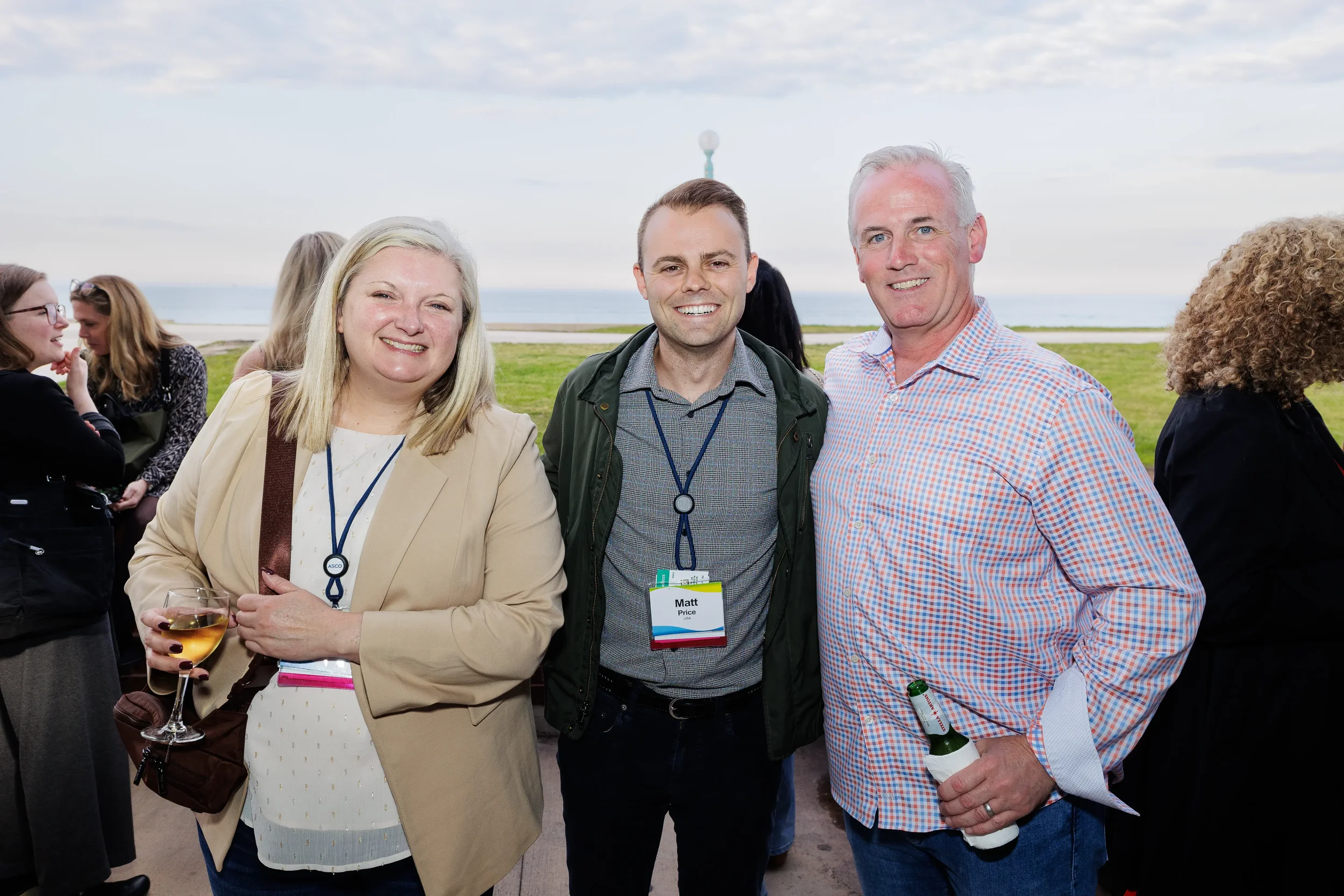 Three attendees pose together during outdoor reception at Orlando networking event