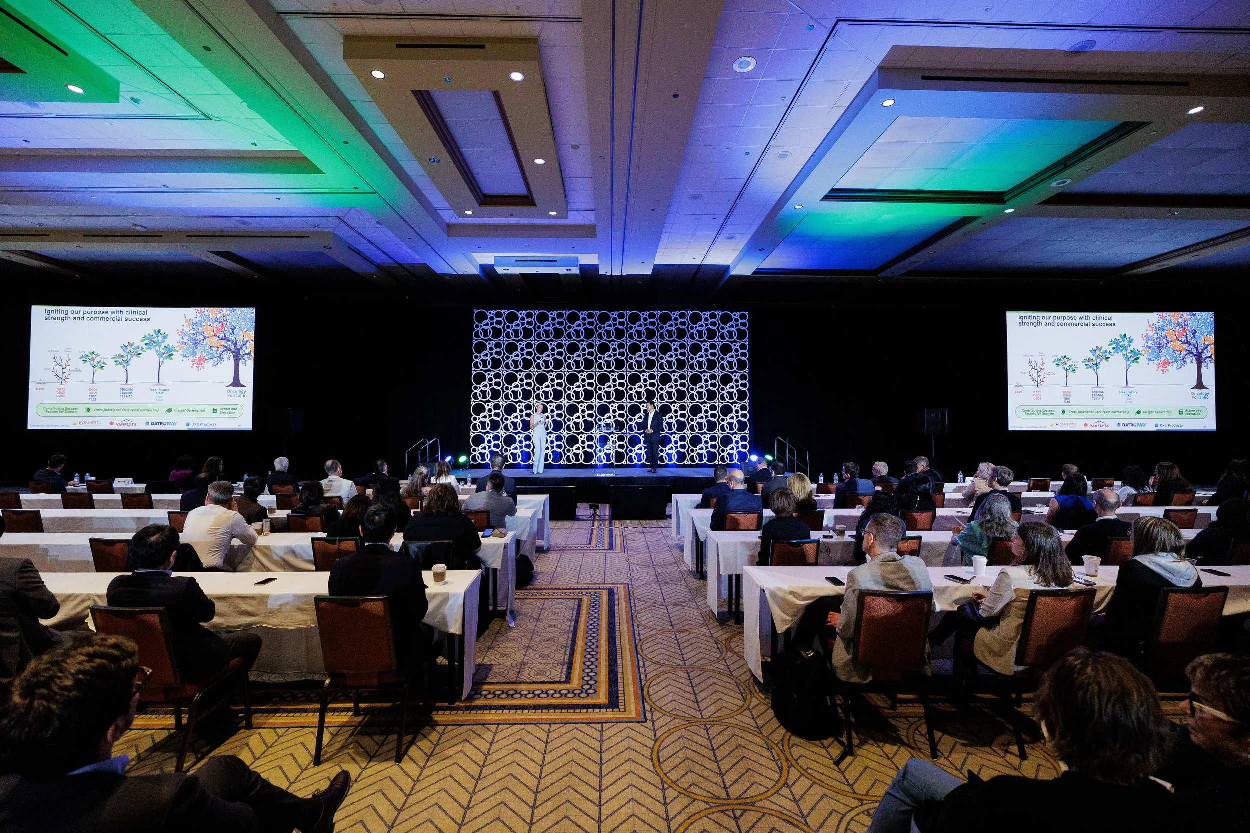 Wide view of audience watching stage presentation in ballroom at Chicago corporate conference